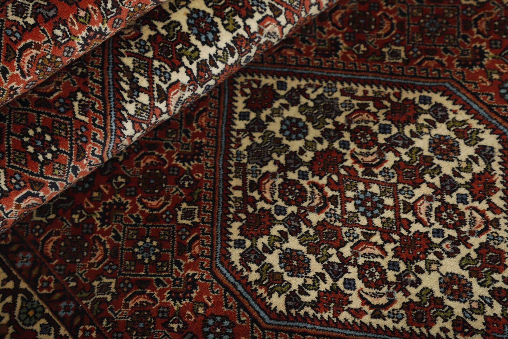 Red and cream persian runner with traditional floral design