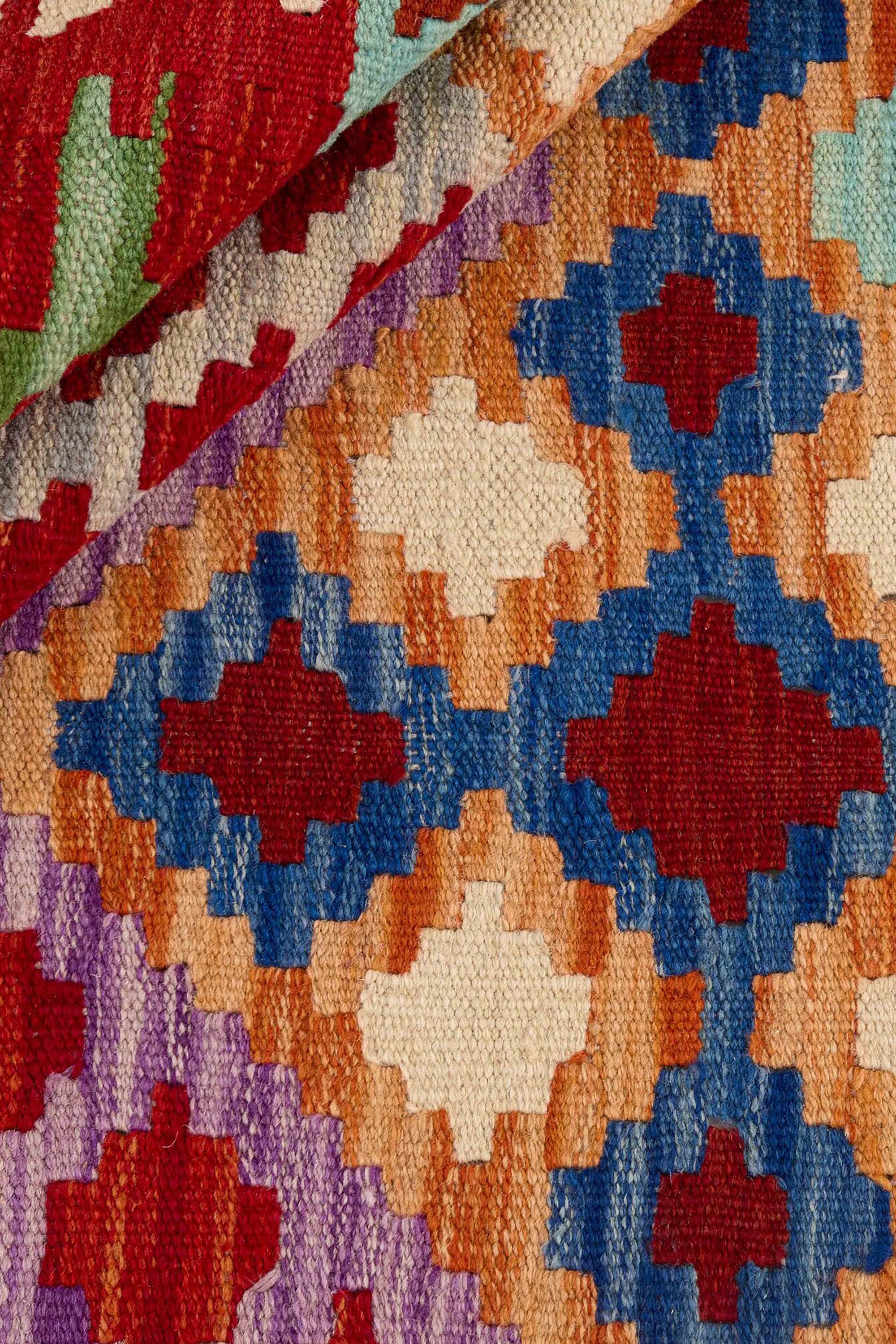 Authentic Afghan Kelim flatweave rug with traditional multicolour pattern.