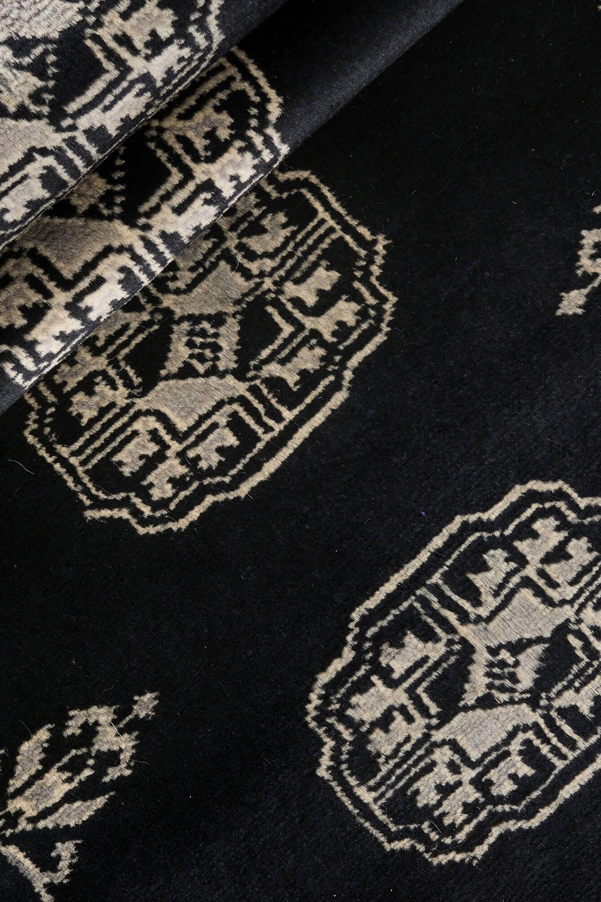 Black Oriental runner with traditional bordered pattern
