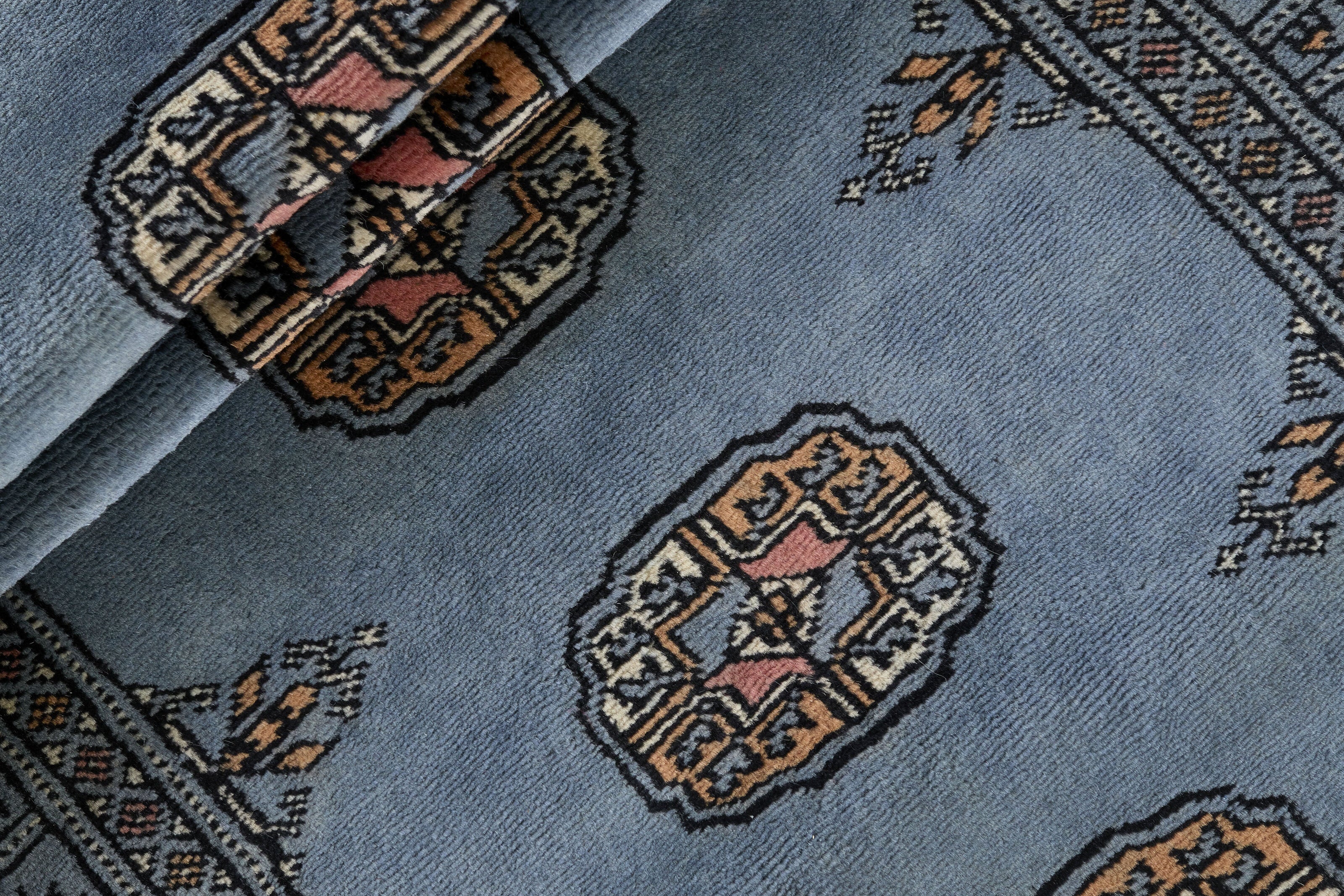 Blue Oriental runner with traditional bordered pattern