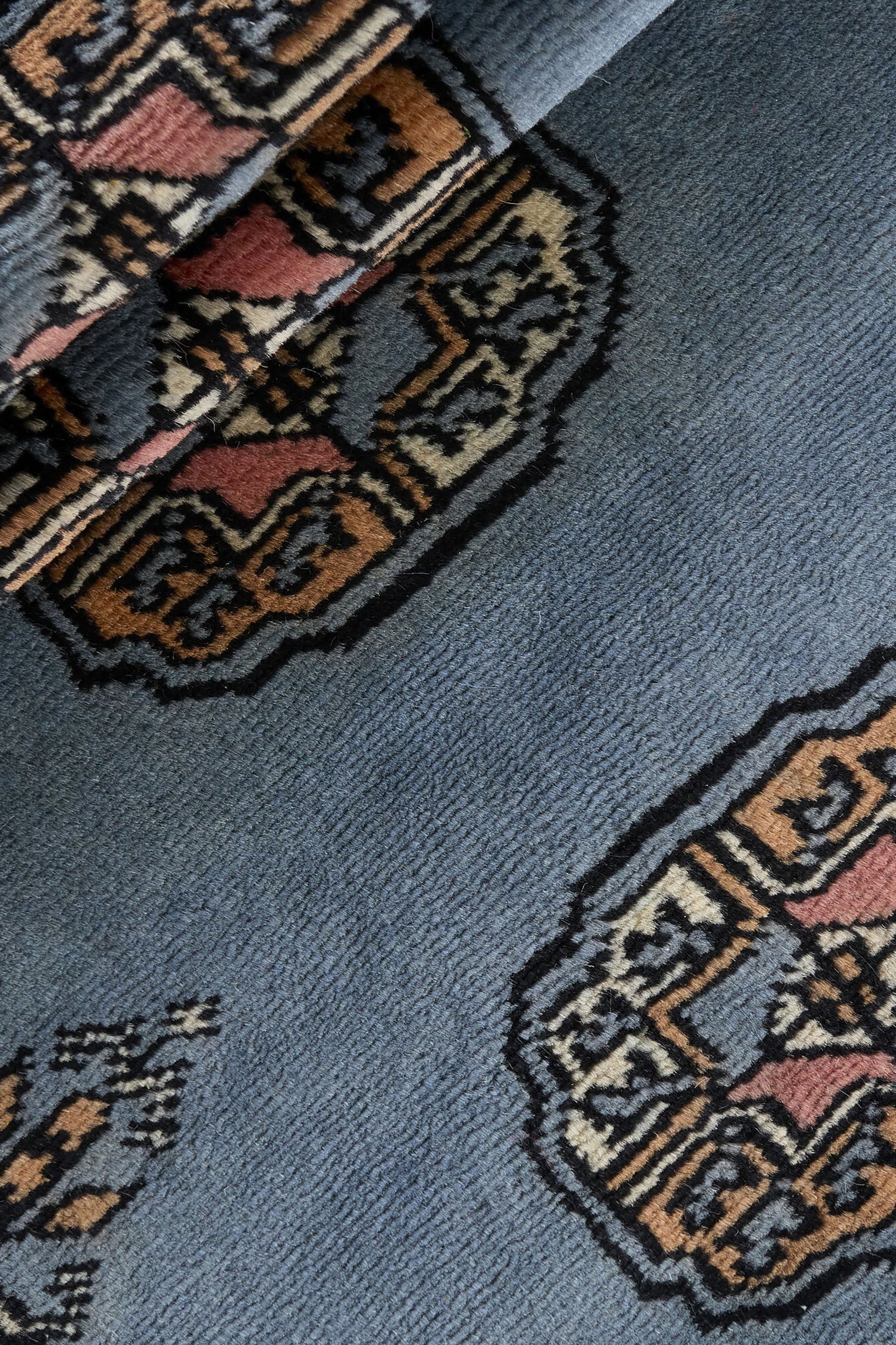 Blue Oriental runner with traditional bordered pattern