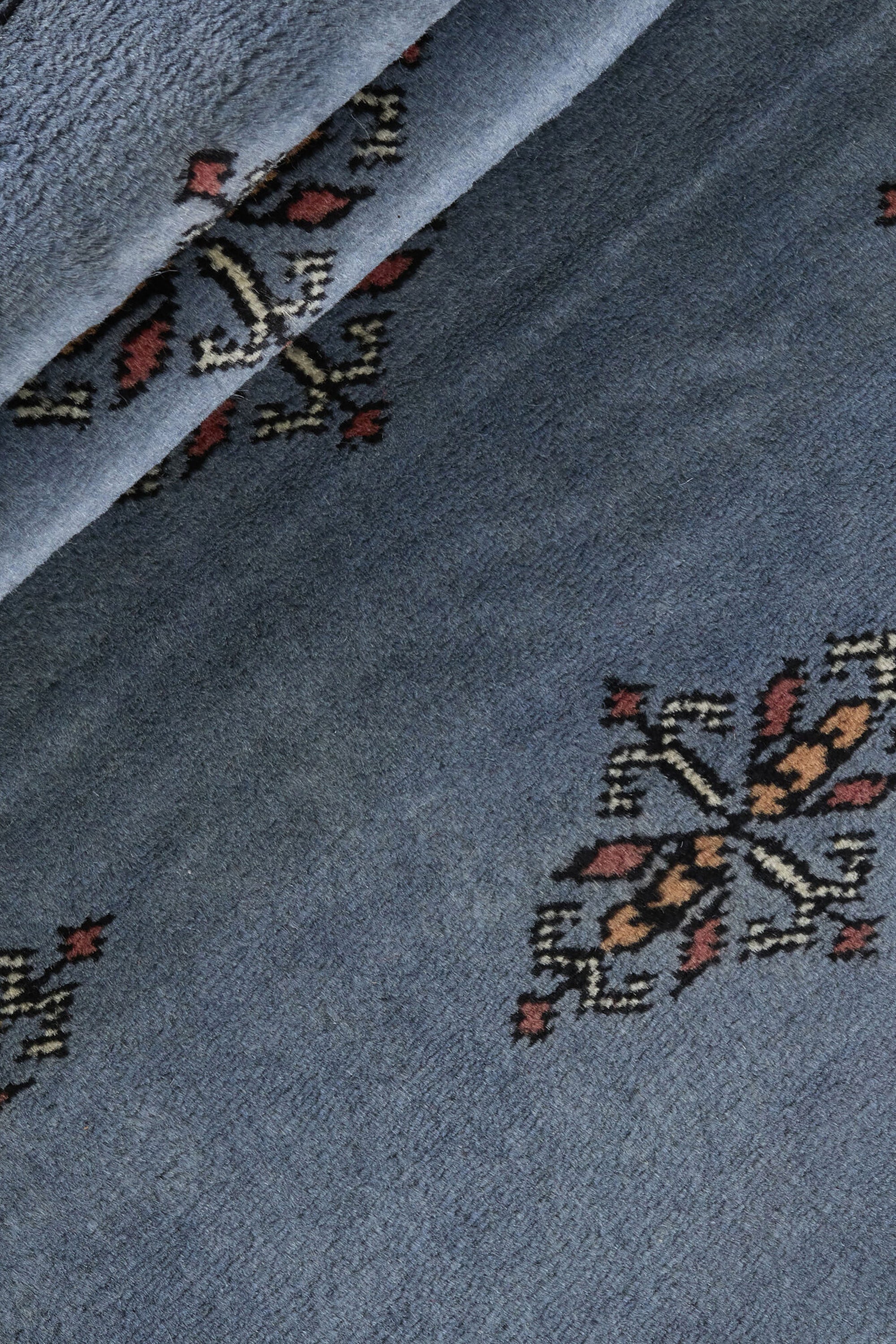 Blue Oriental runner with traditional bordered pattern