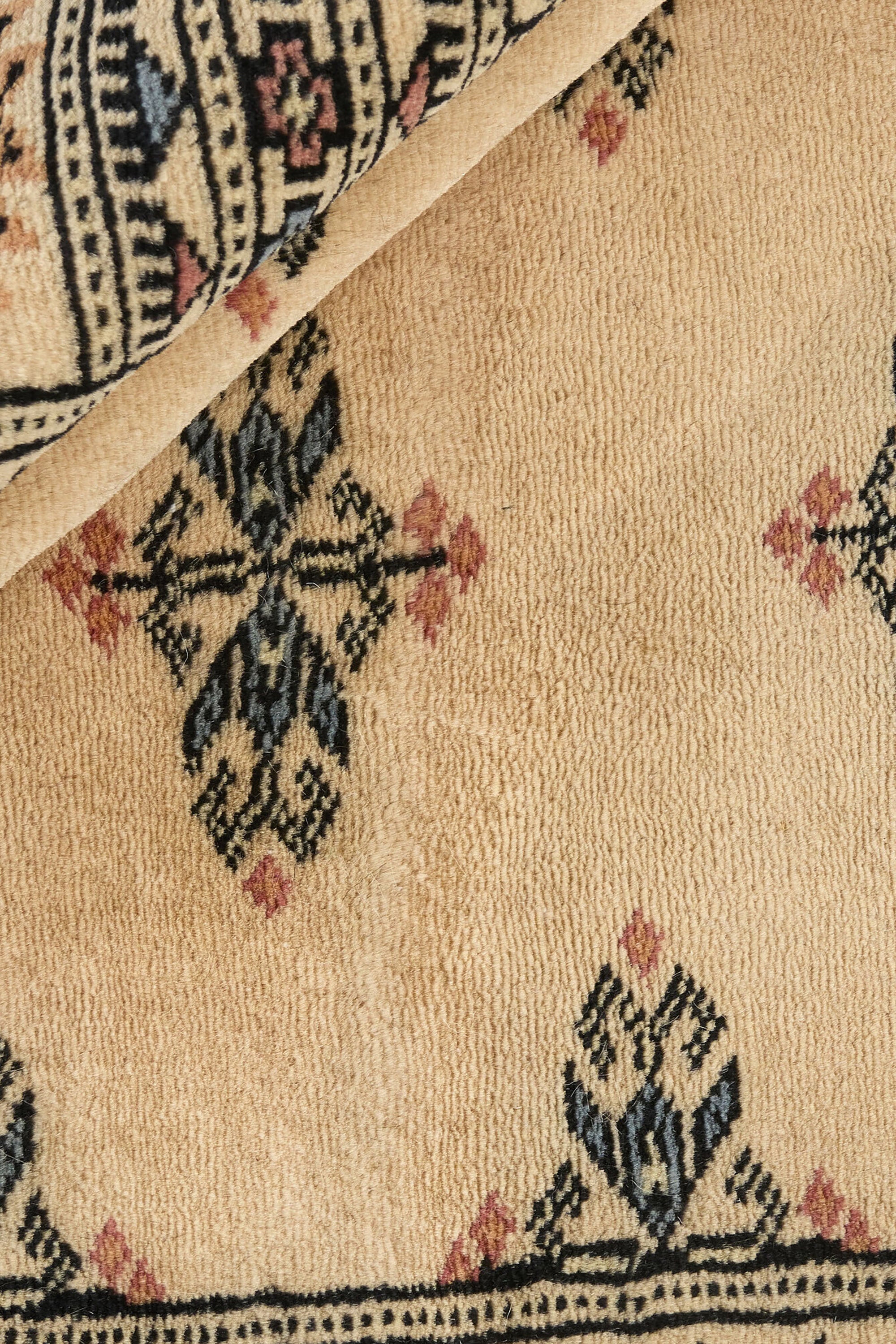 Beige Oriental rug with traditional bordered pattern