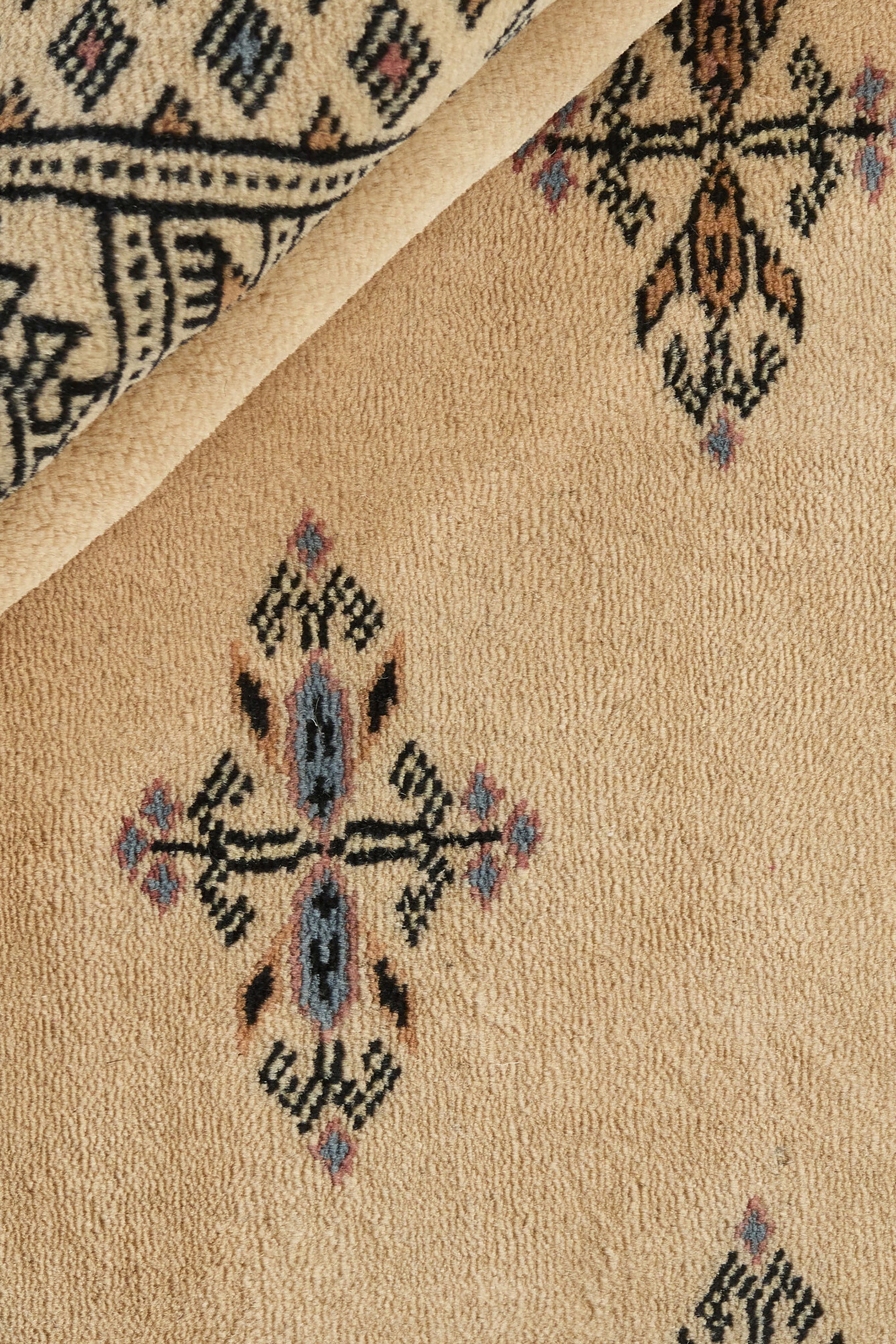 Beige Oriental rug with traditional bordered pattern