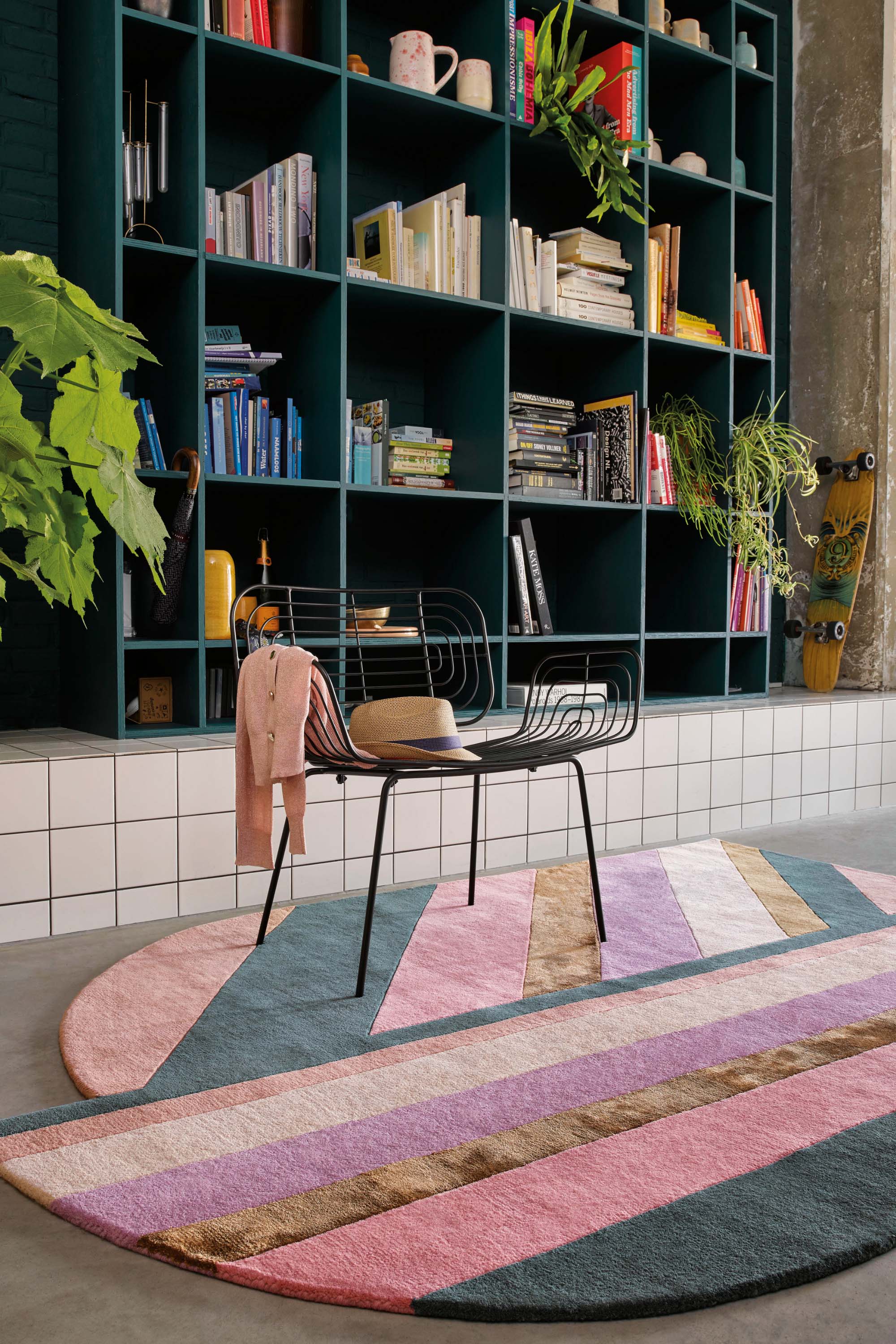 Striped pink, teal and gold rug in an abstract shape