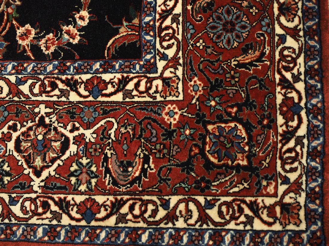Red and black persian rug with traditional floral design