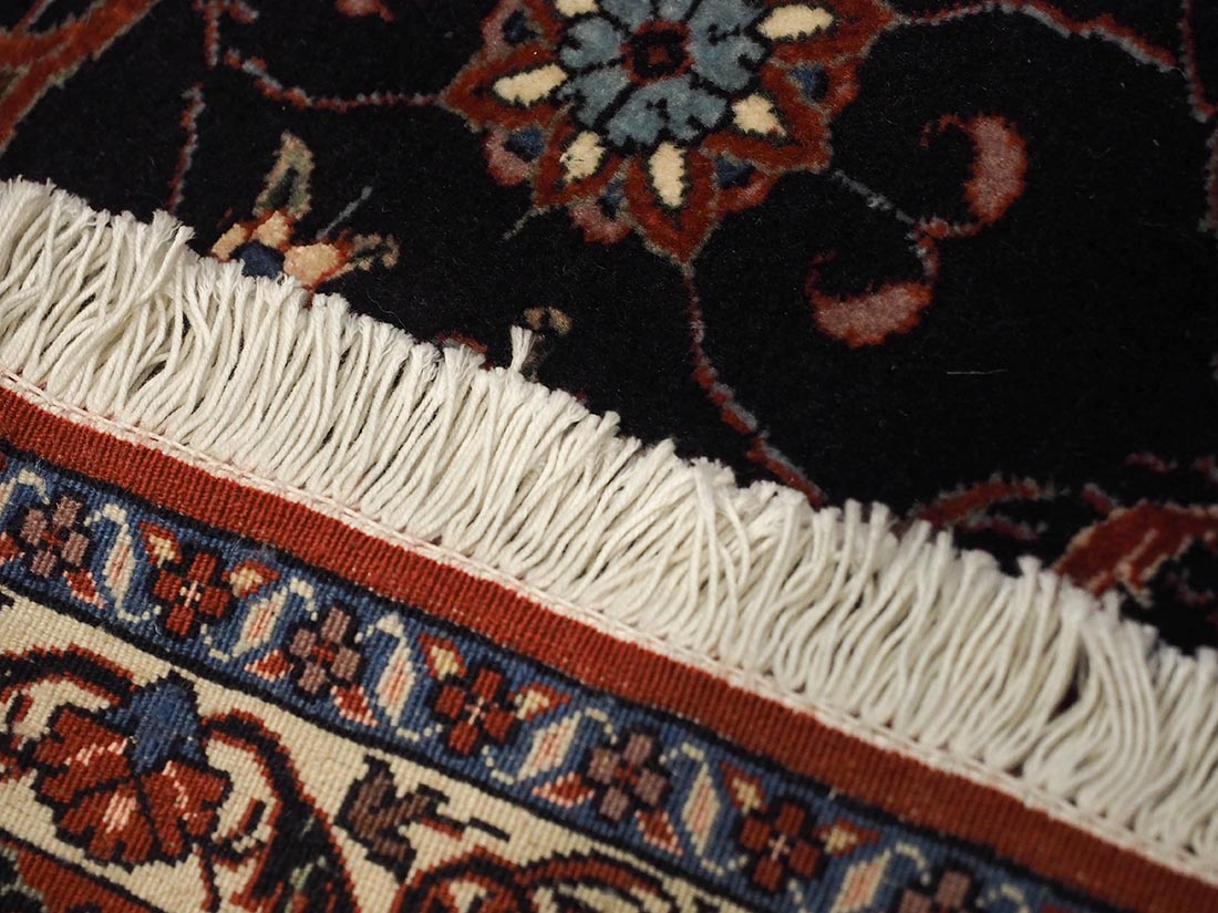 Red and black persian rug with traditional floral design