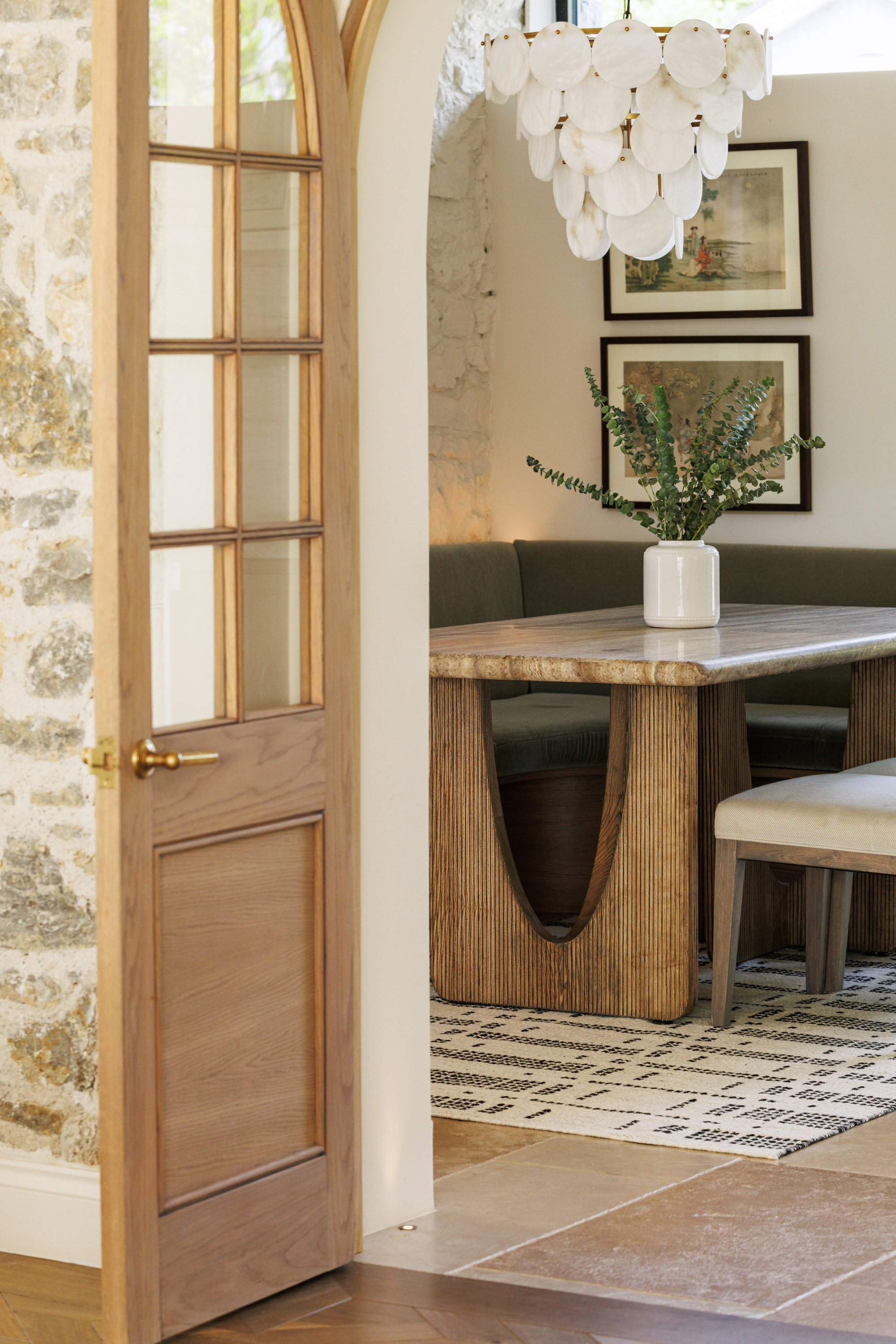 White wool and cotton rug with a black geometric pattern inspired by the Manhattan skyline at night place under a dining table