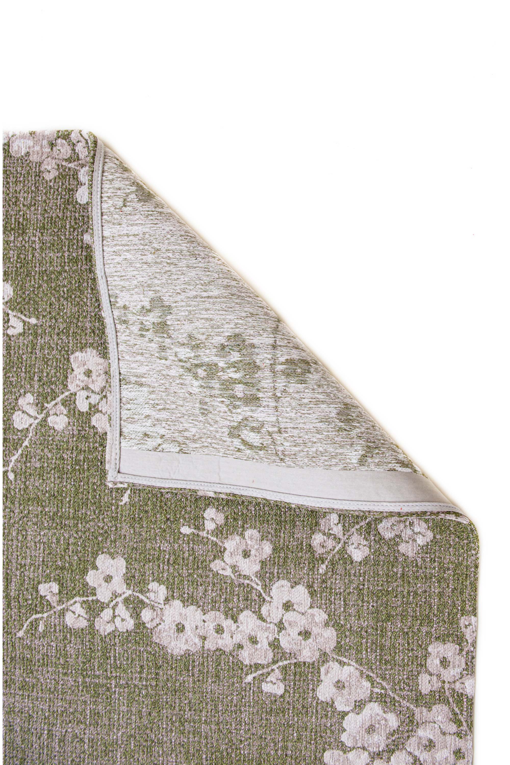 Modern abstract rug with subtle green floral pattern