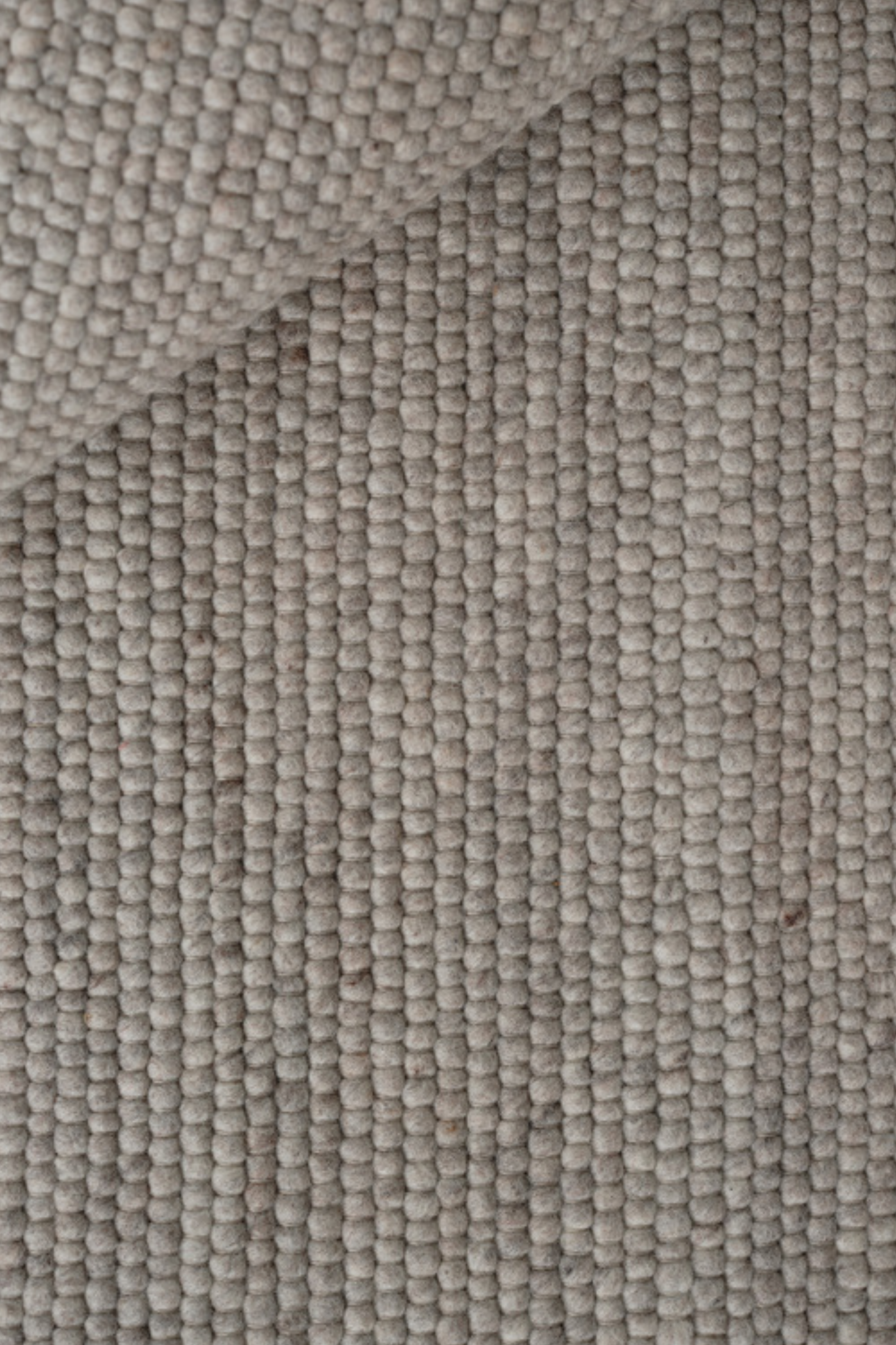 Light grey textured woven rug