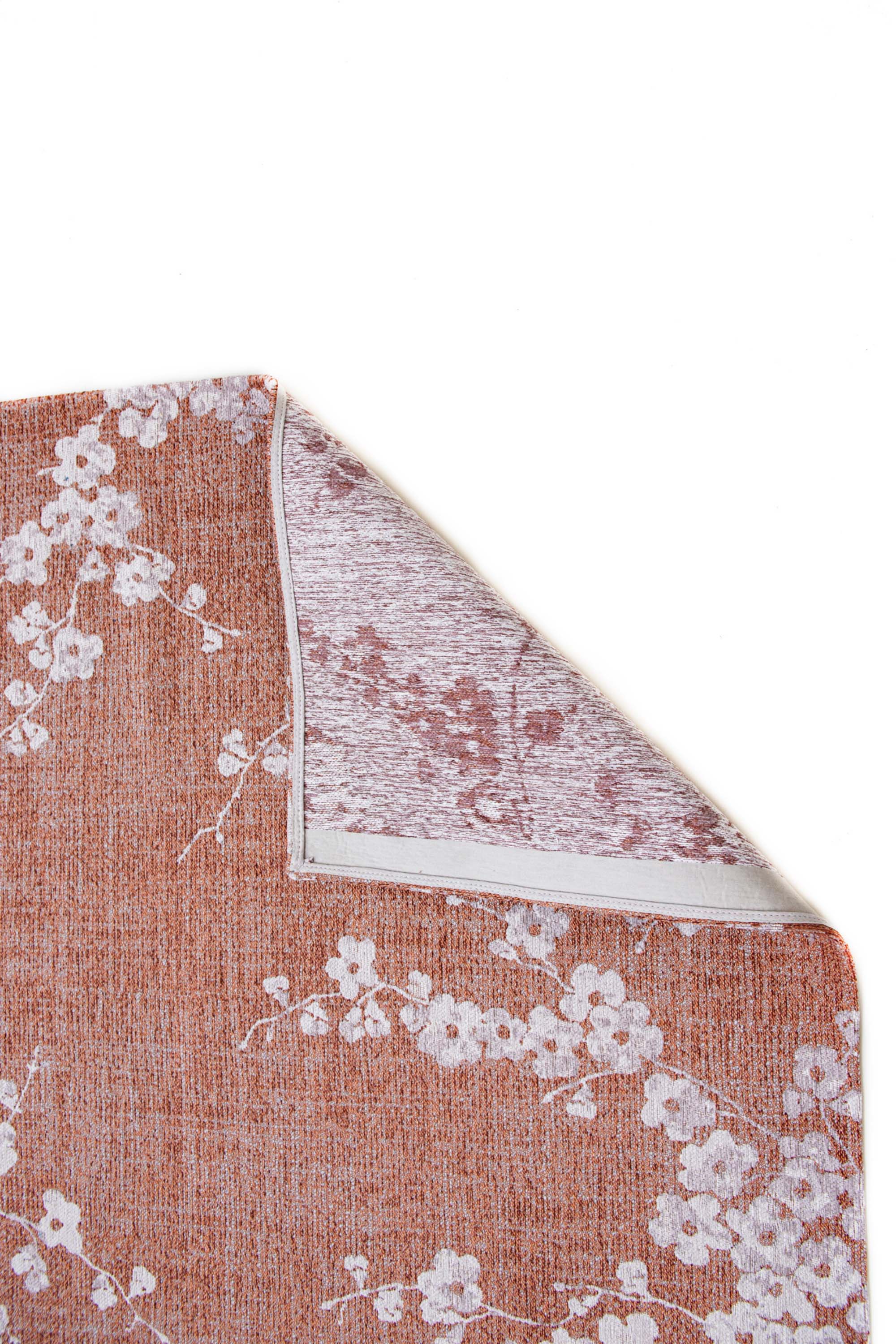 Modern abstract rug with subtle pink floral pattern