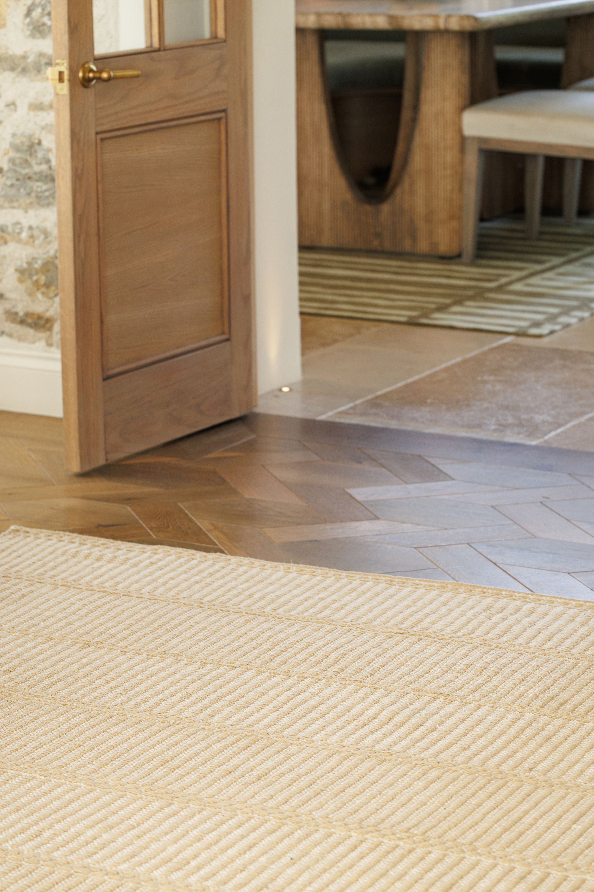 wool and cotton rug in a golden straw tone featuring a design inspired by ancient irish script