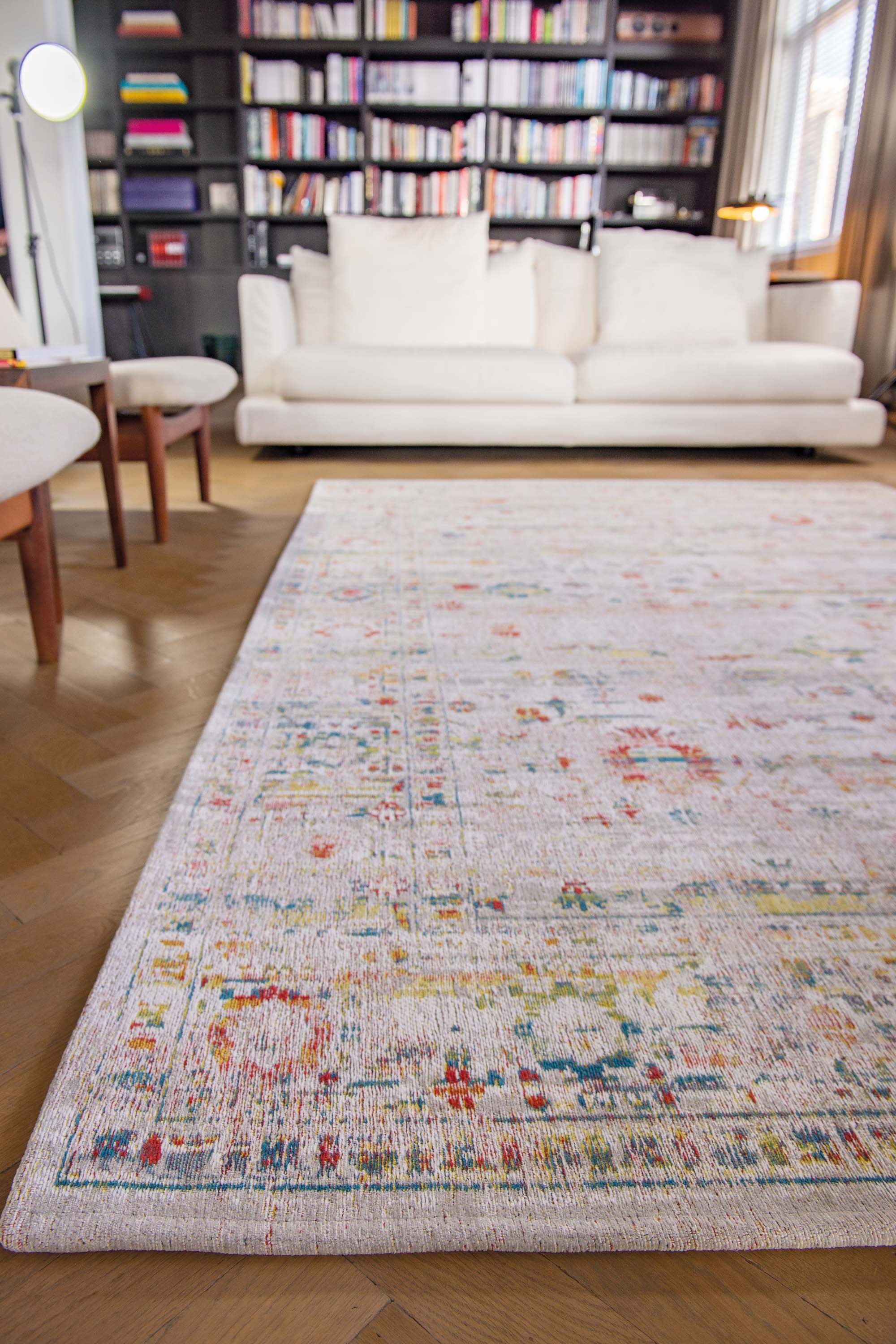 Distressed beige rug with turkish floral medallions and border in teal, terracotta and yellow