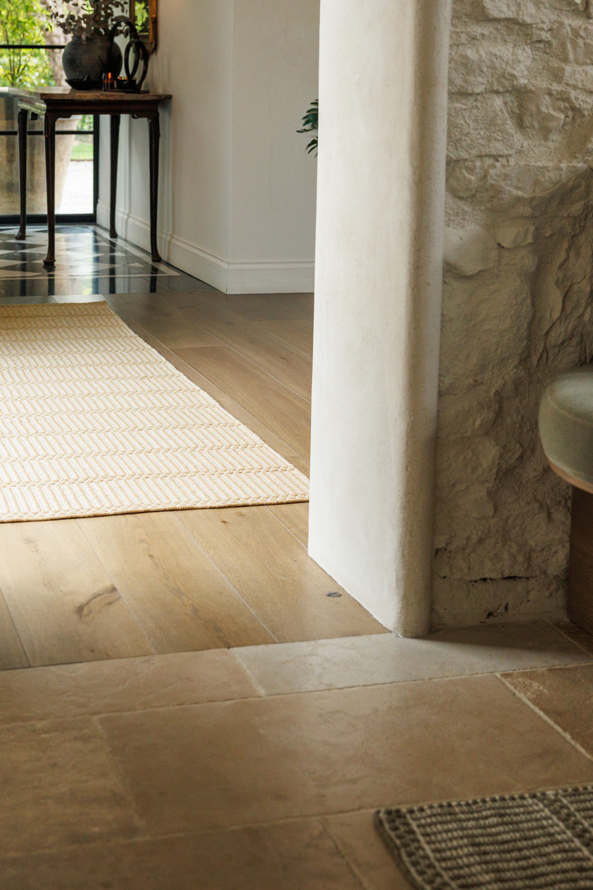 wool and cotton runner rug in a golden straw tone featuring a design inspired by ancient irish script placed in a hallway