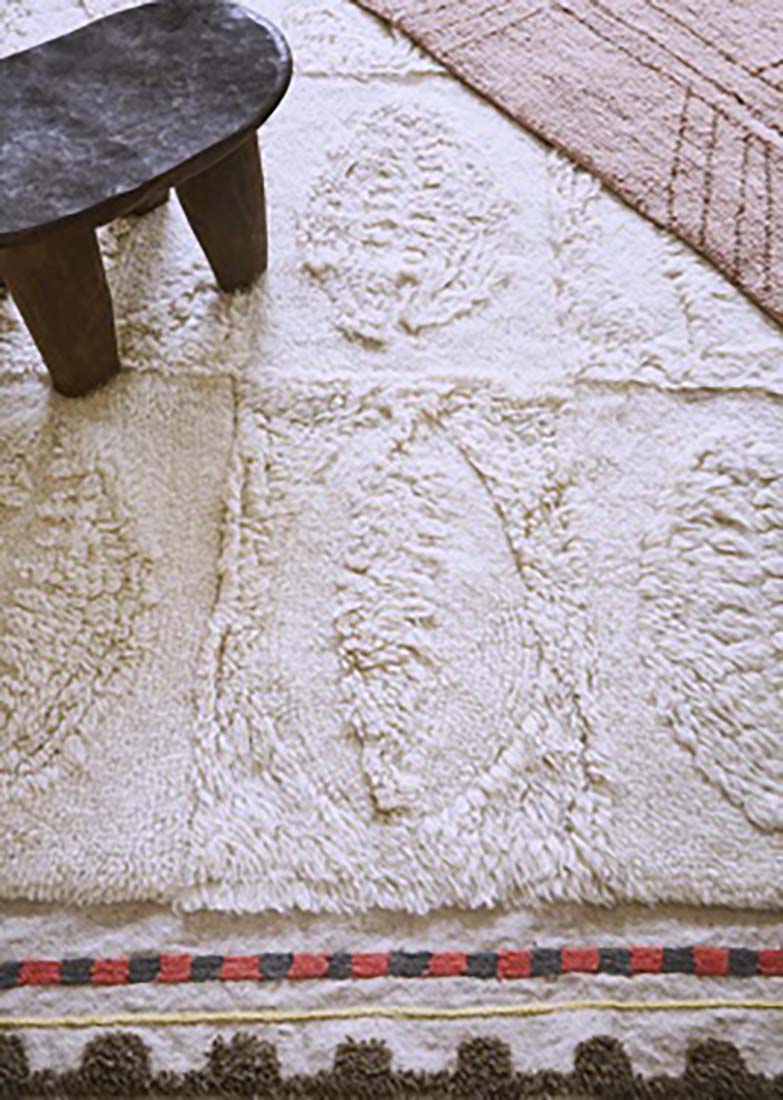 cream area rug with embossed shell design
