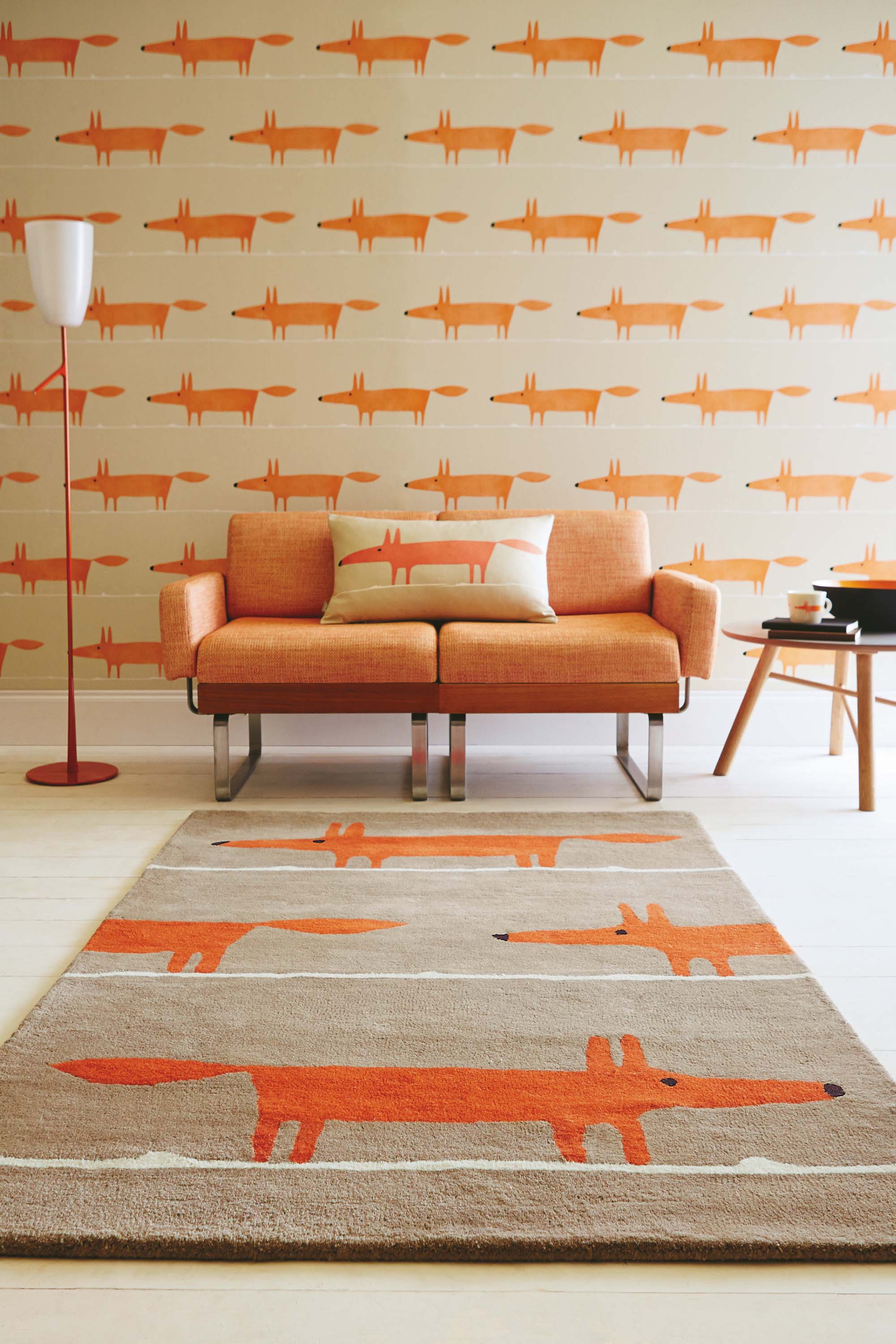 Pink rectangular rug decorated with white lines and a repeating grey fox pattern