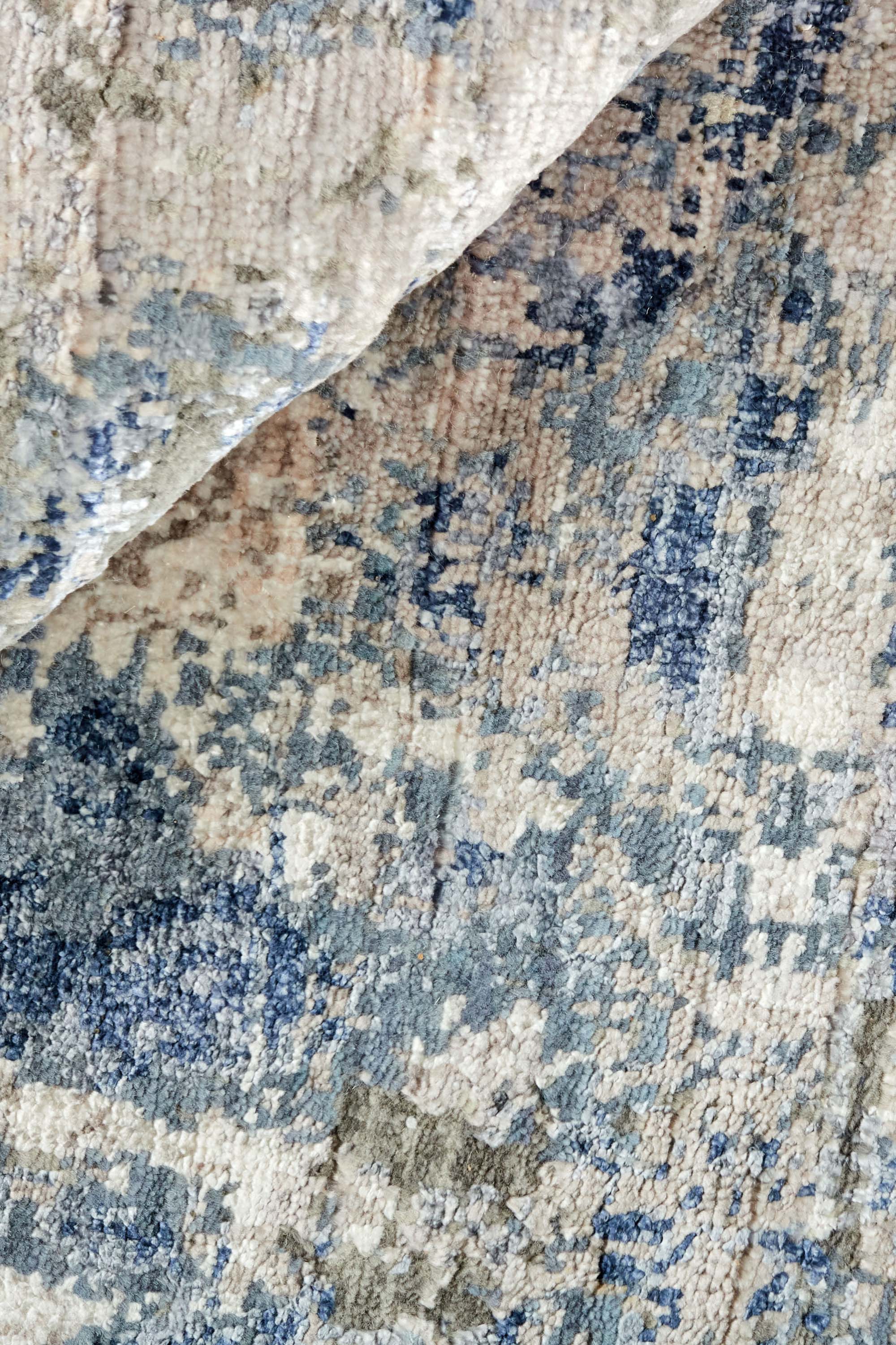 Modern luxury abstract rug in shades of silver and blue