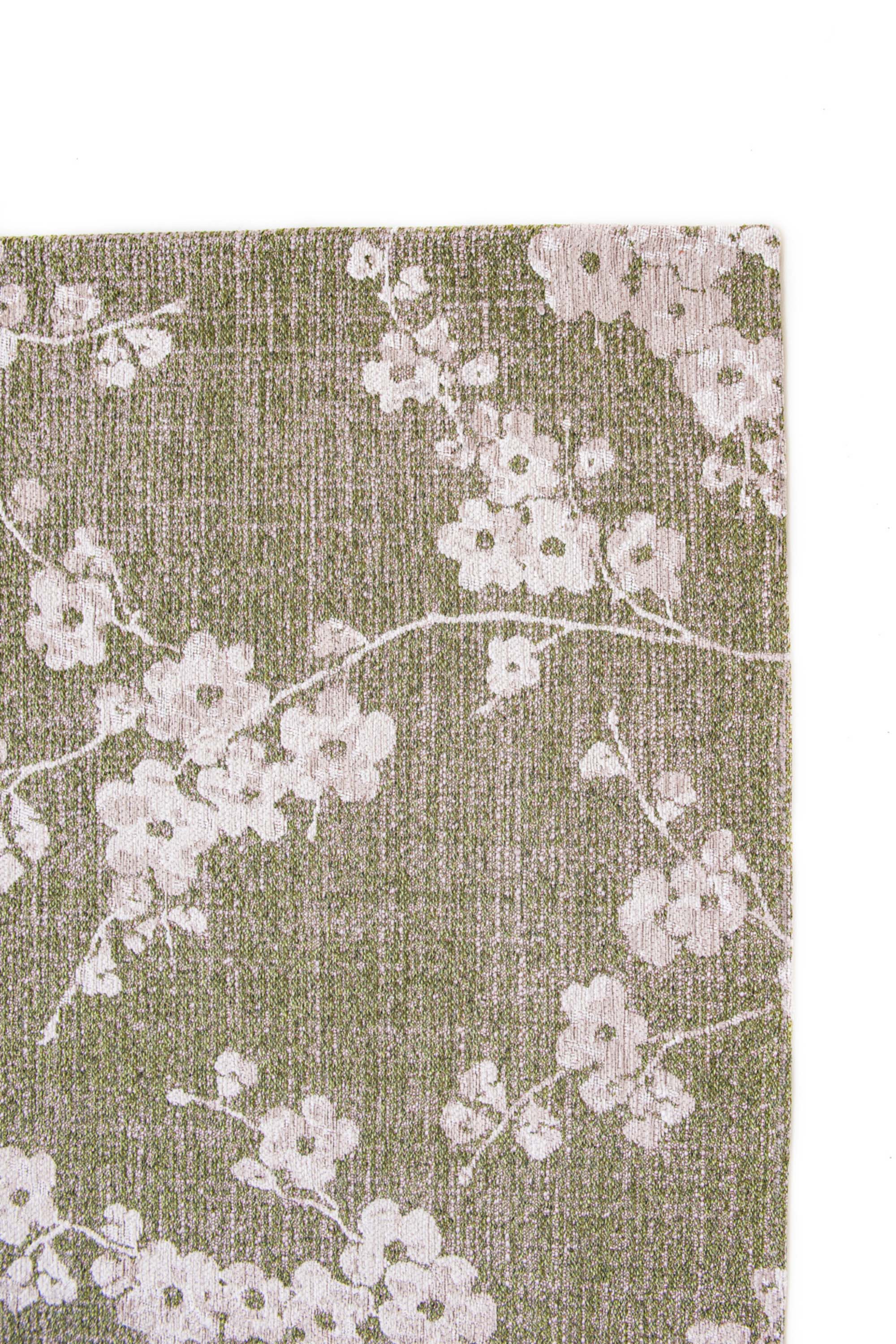 Modern abstract rug with subtle green floral pattern