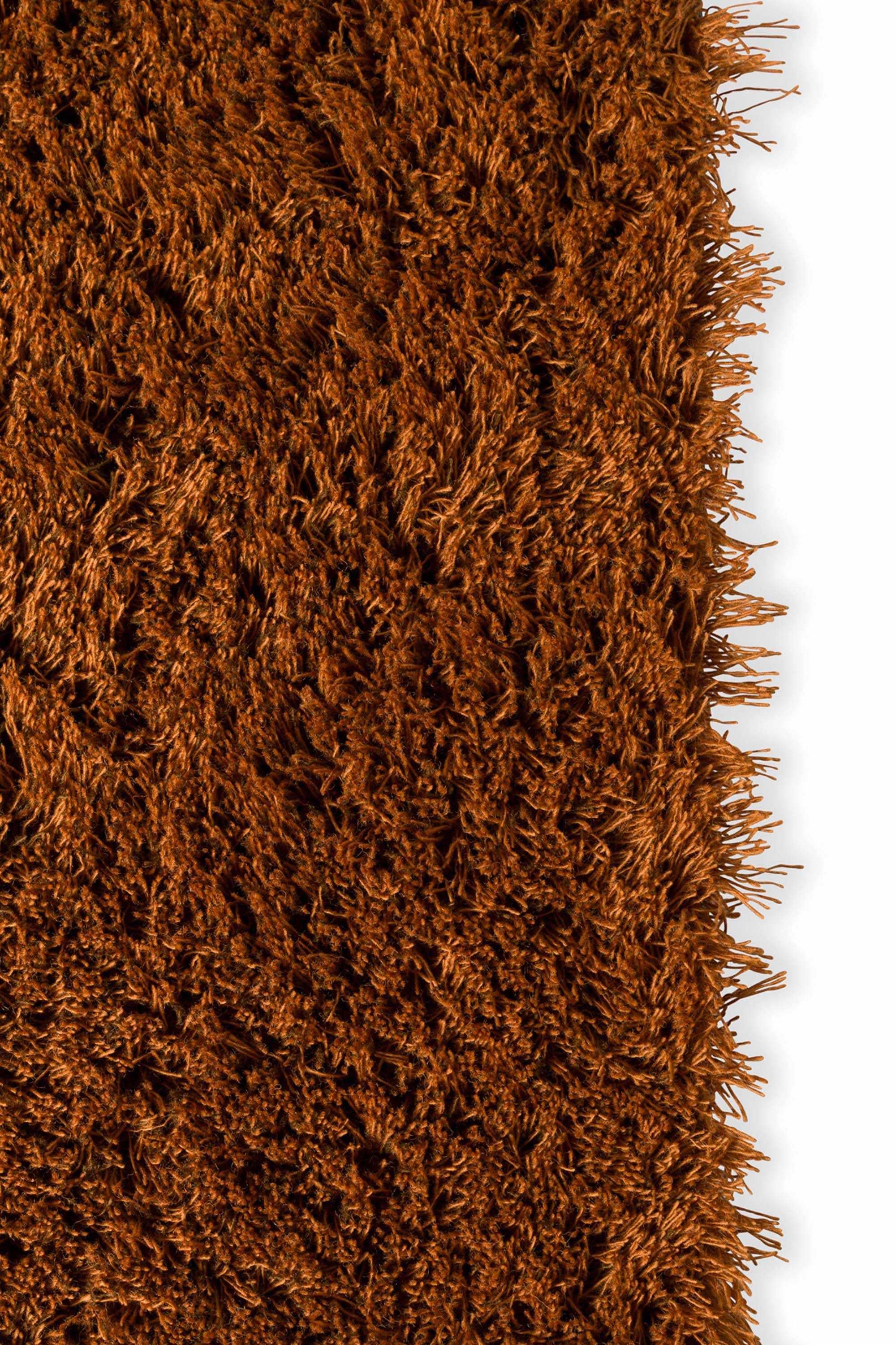 Plain orange rug with shaggy pile