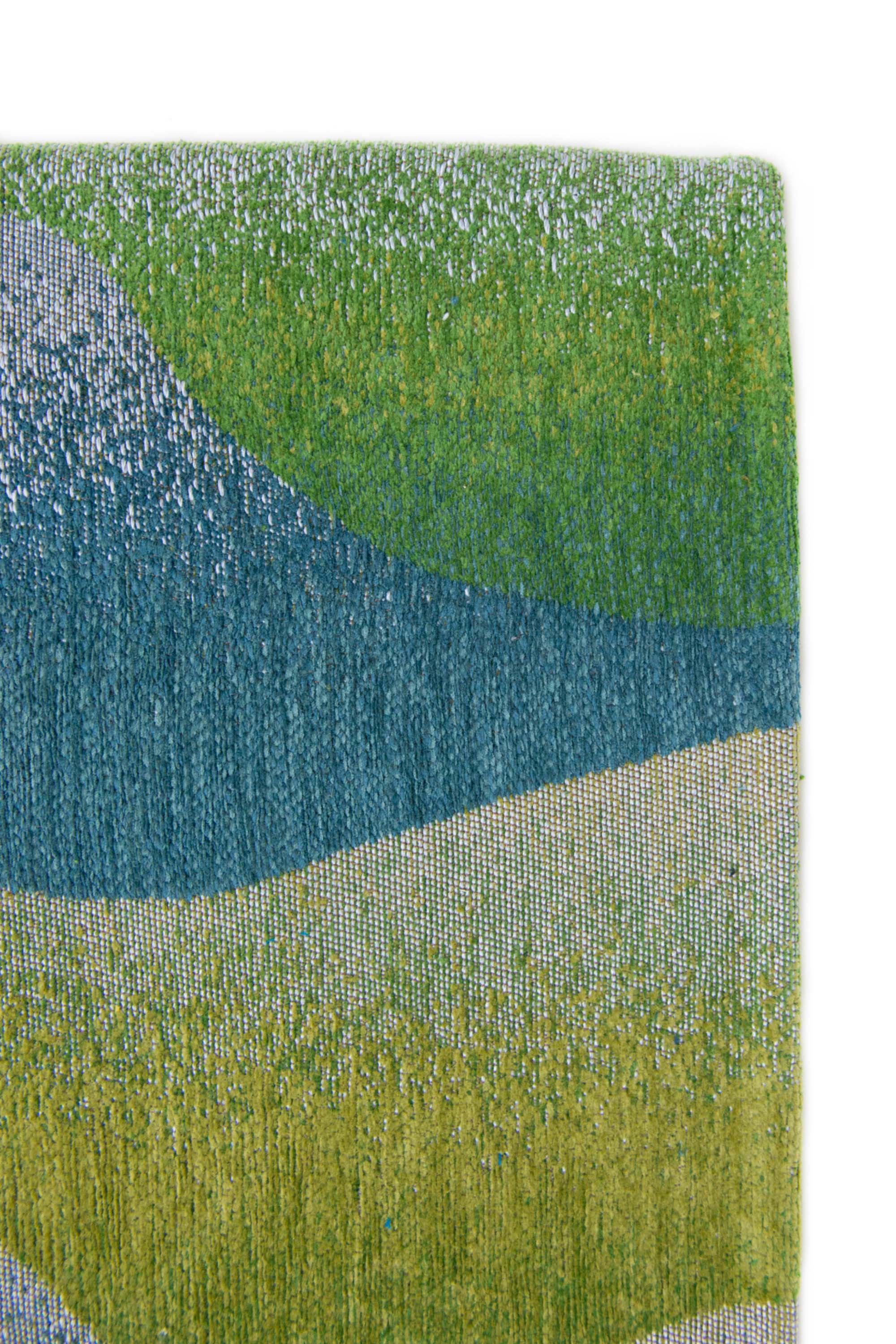 Modern rug with green abstract mountain range pattern