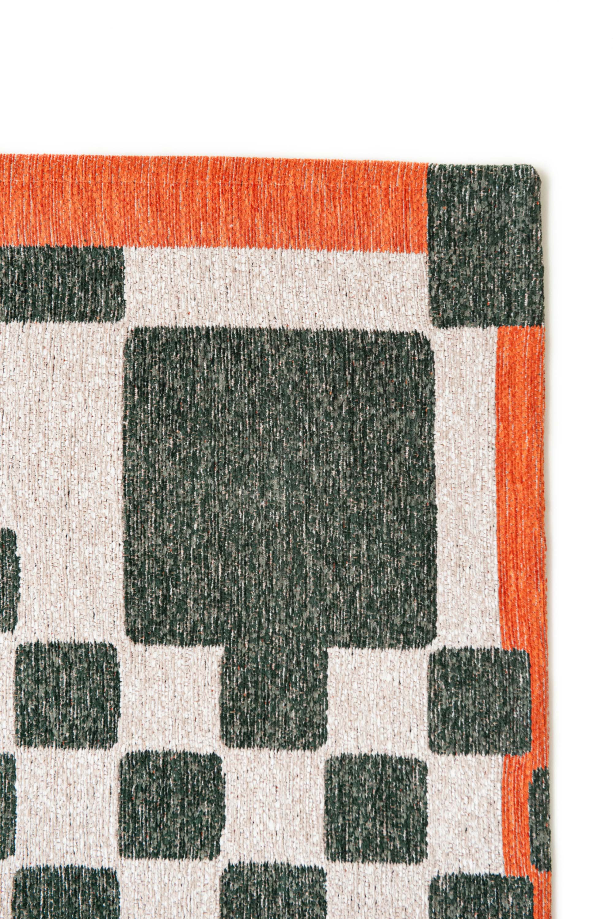 Abstract geometric rug with green, orange, and white tones