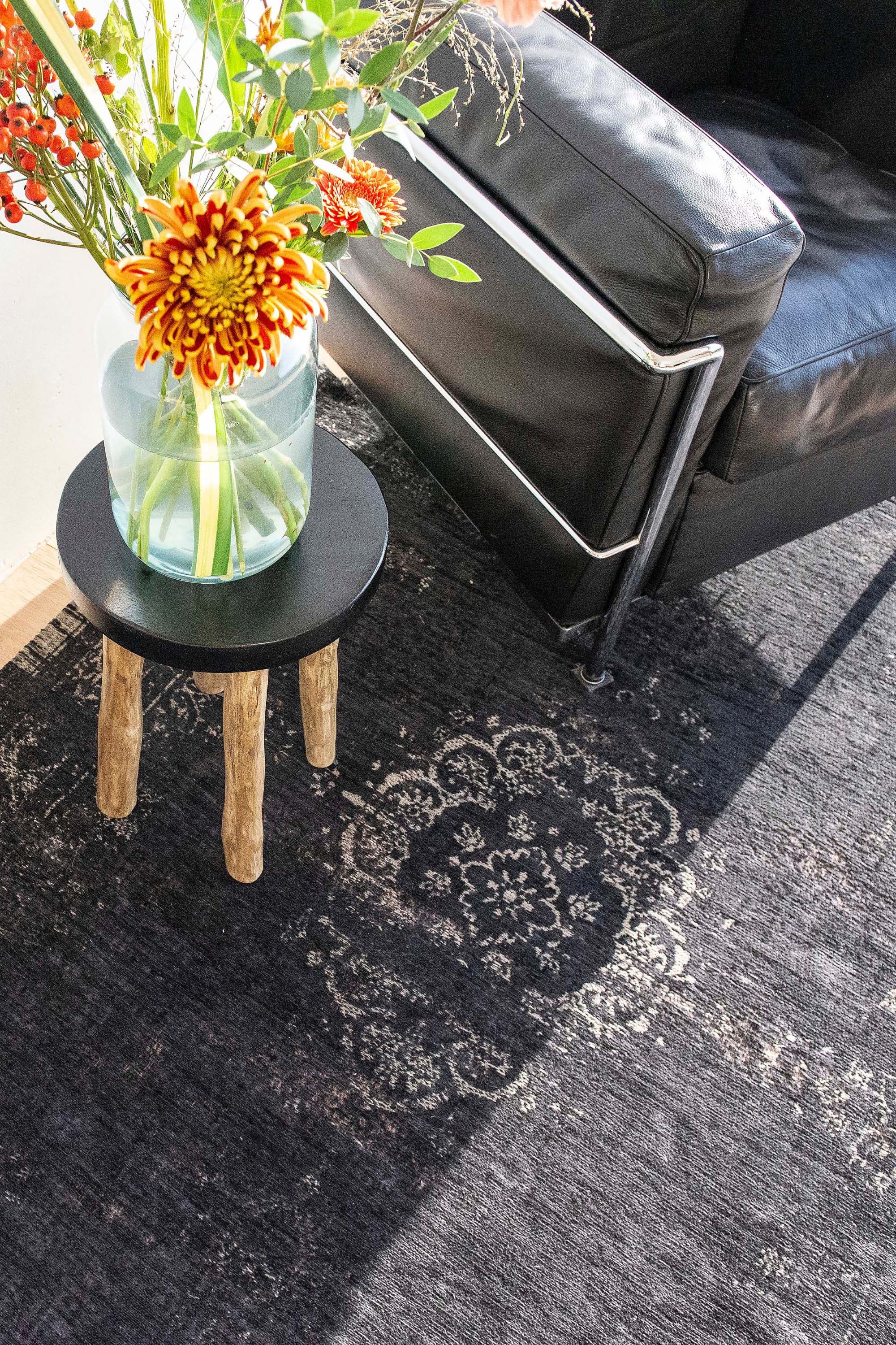 Black flatweave rug with faded persian design