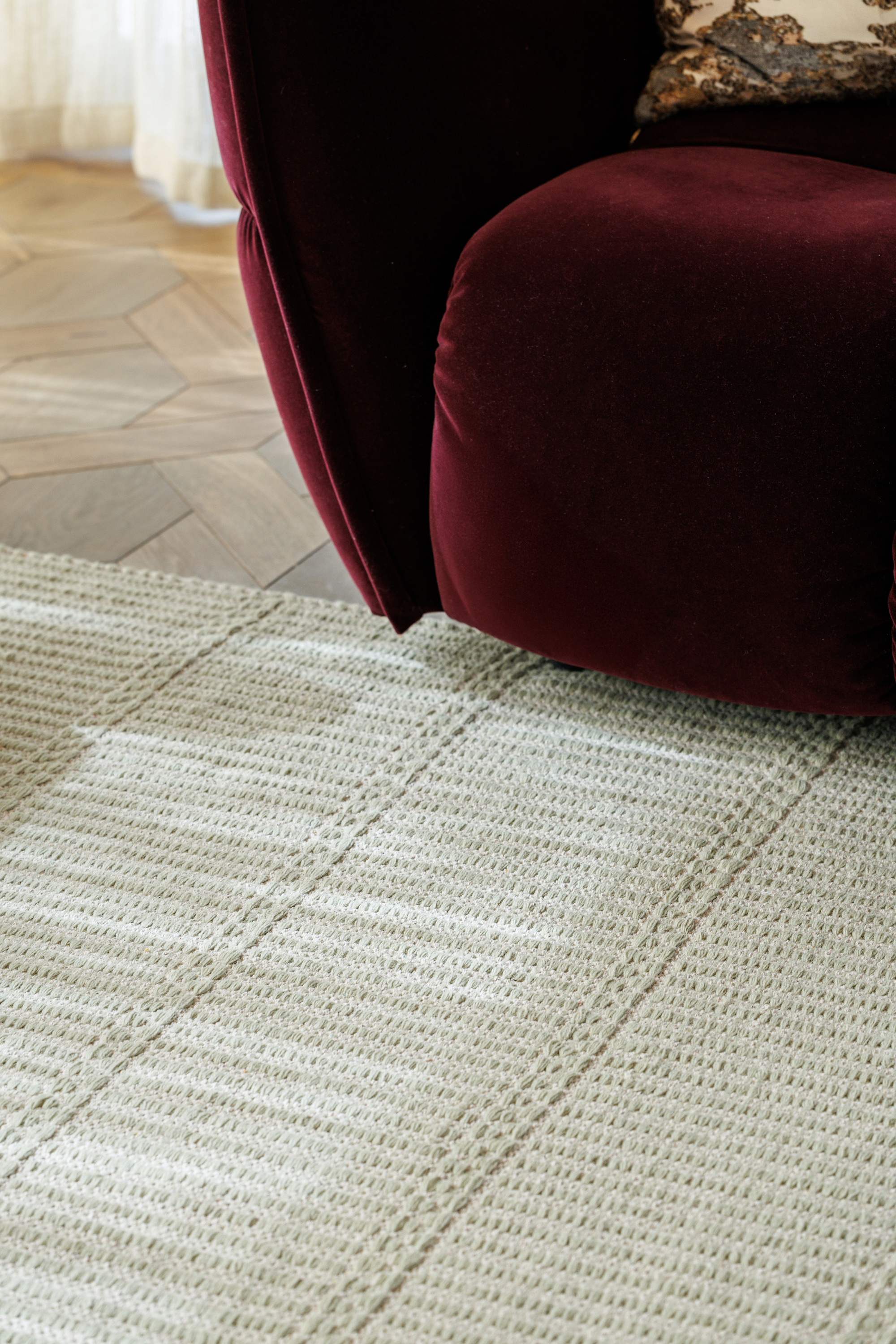 wool and cotton rug in soft olive hues featuring a design inspired by ancient irish script