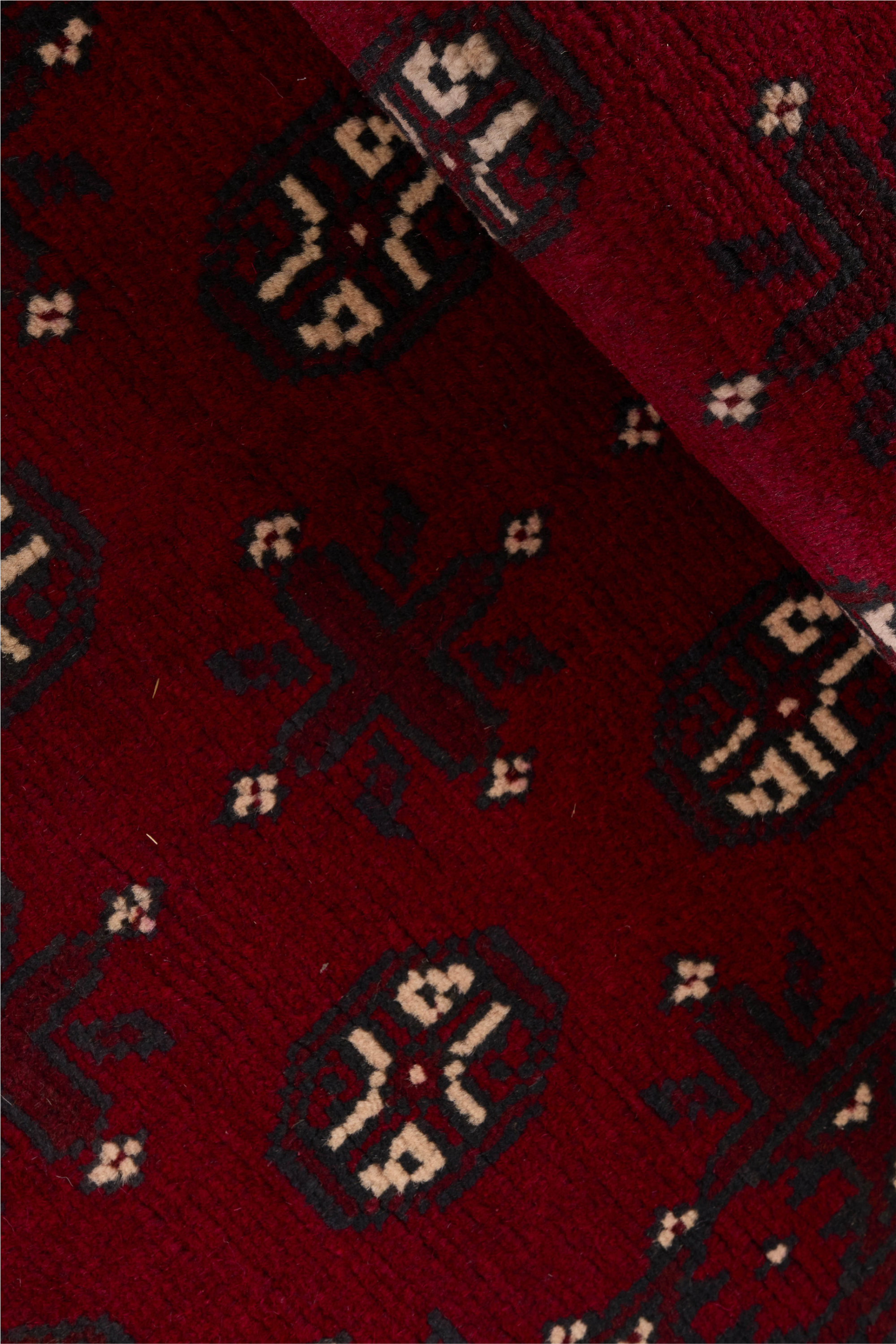 Red oriental wool runner with a traditional elephant's foot pattern
