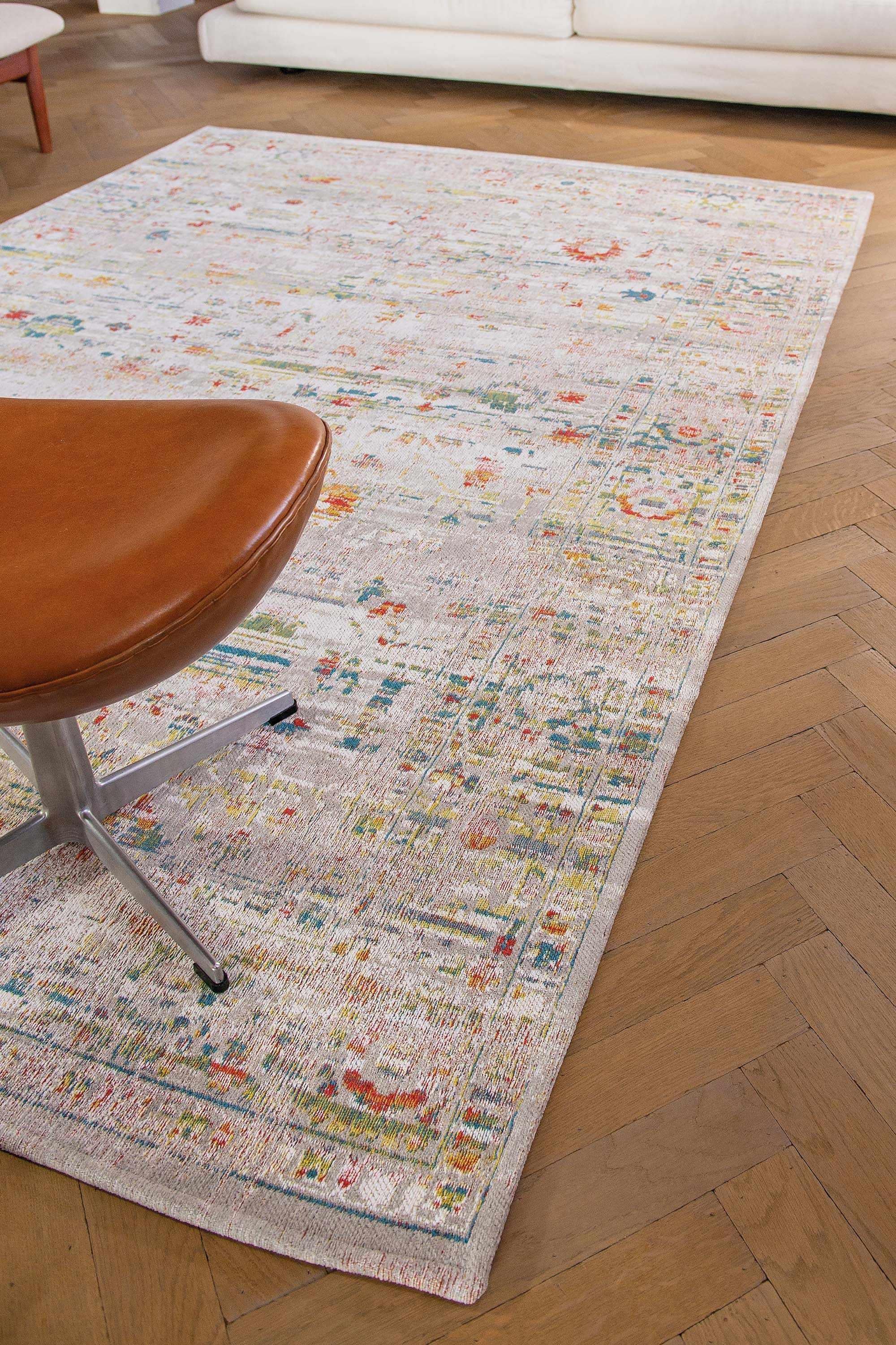 Distressed beige rug with turkish floral medallions and border in teal, terracotta and yellow