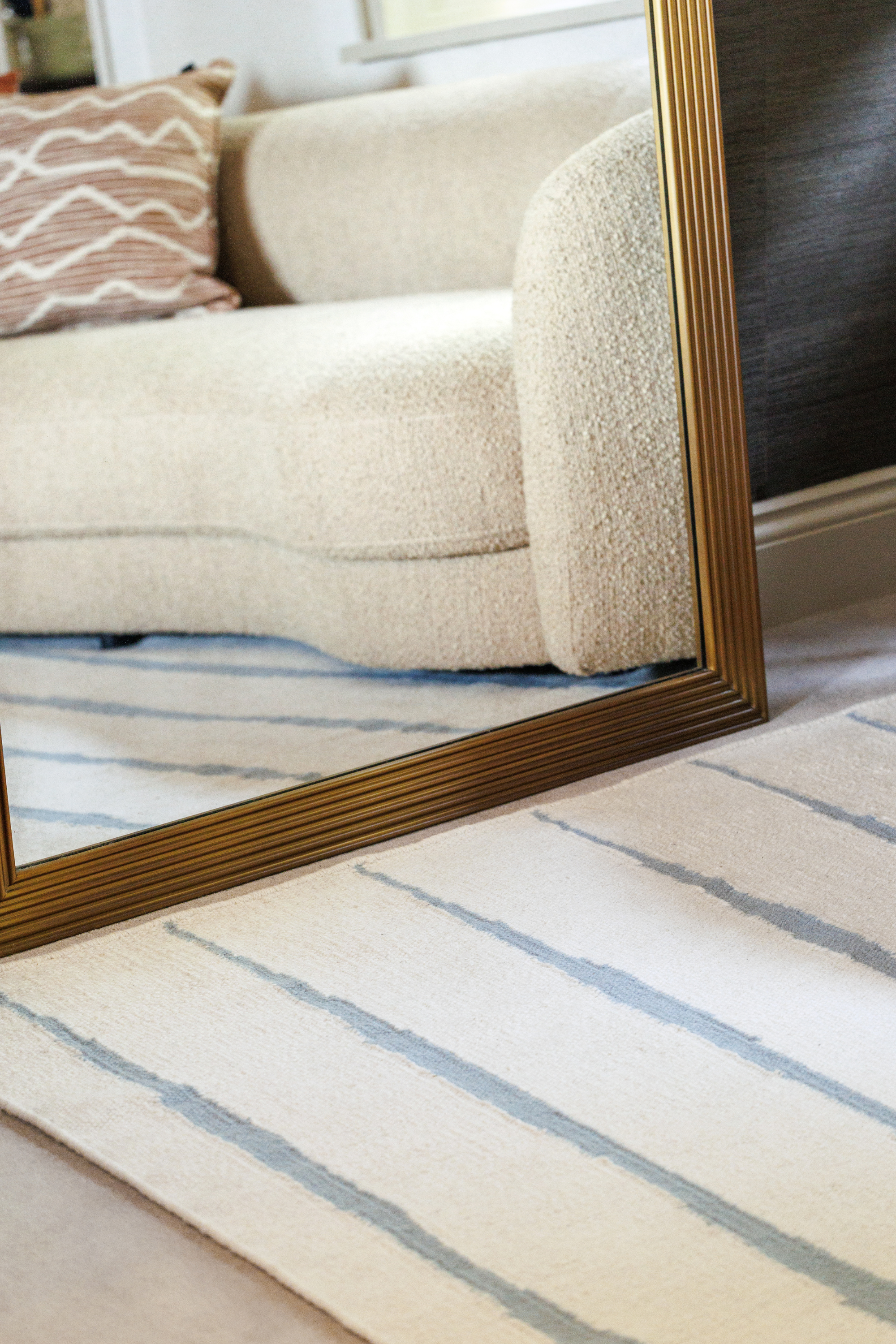 Neutral ivory wool and cotton flatweave rug featuring blue ripple linear lines
