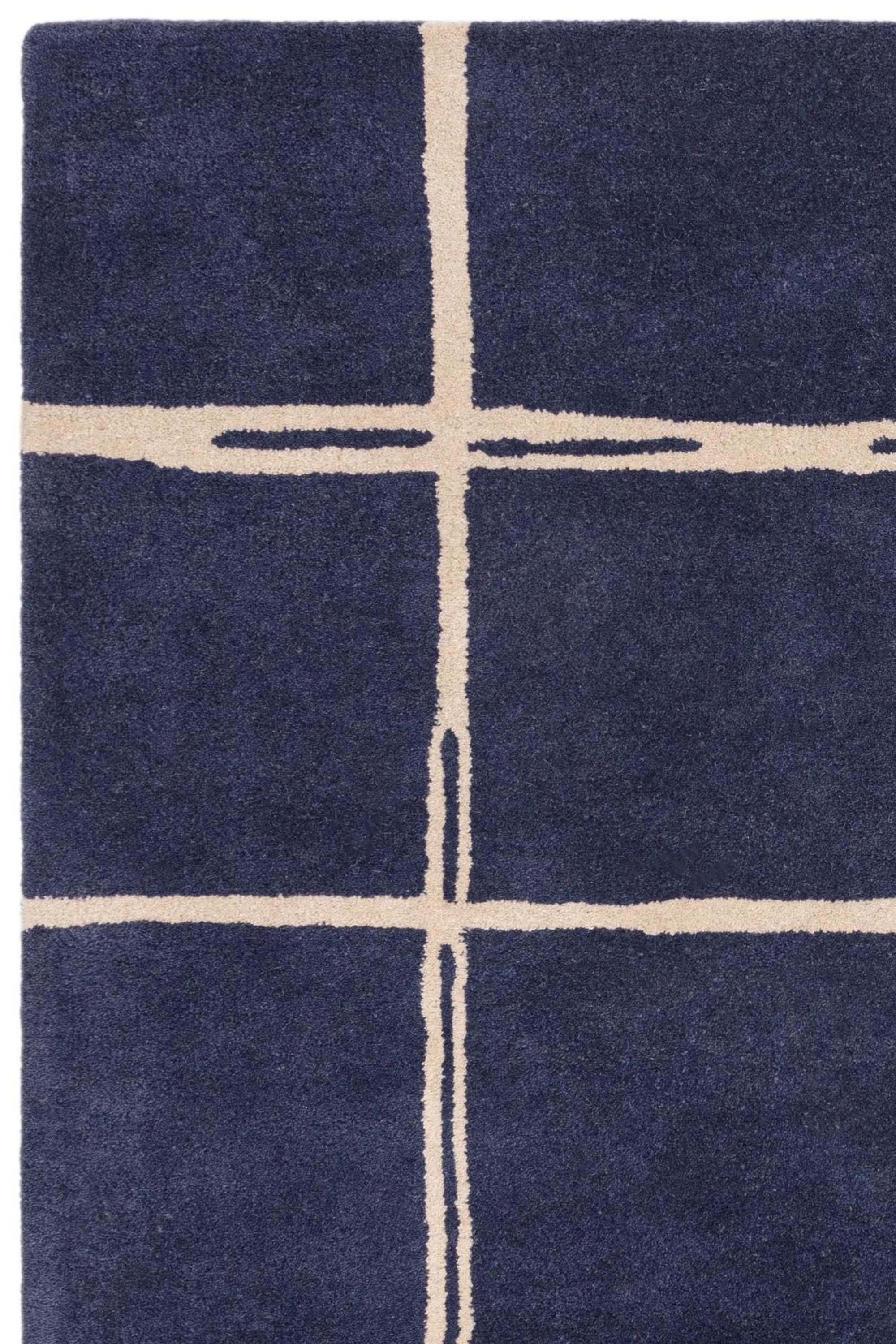Blue rug with minimal geometric pattern