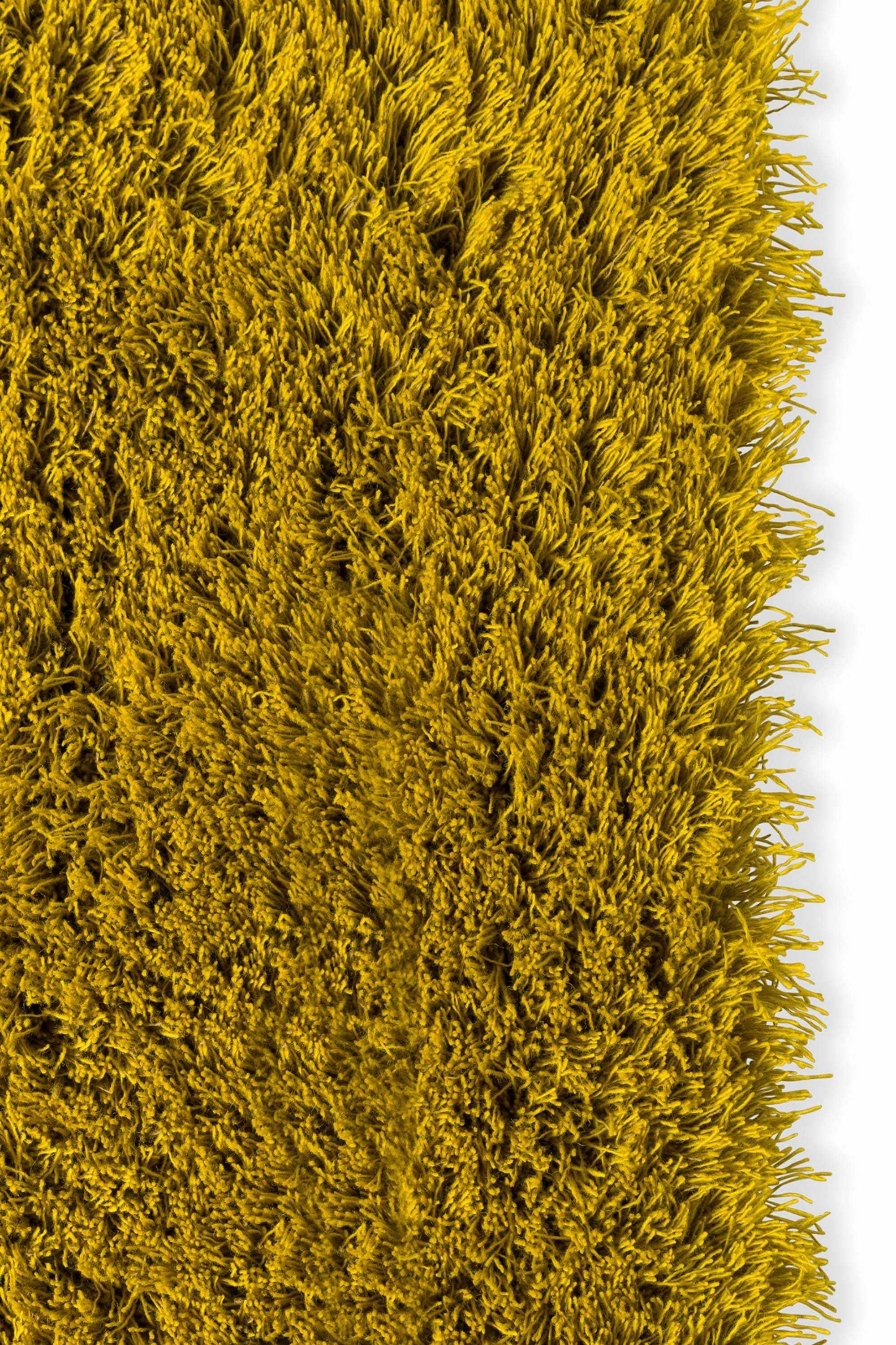 Plain yellow rug with shaggy pile