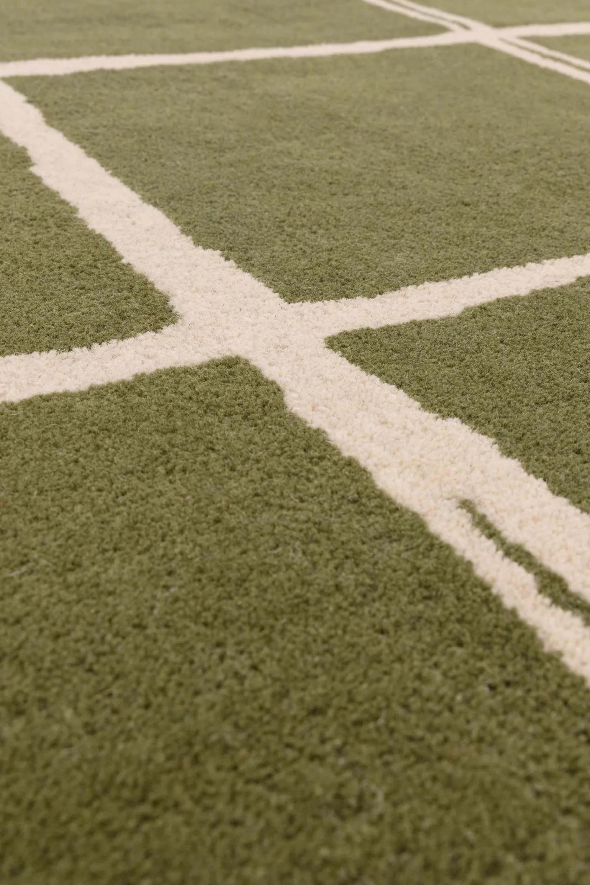 Green rug with minimal geometric pattern