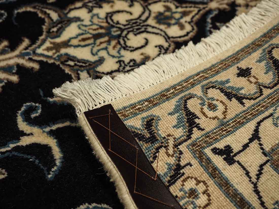 Authentic persian rug with a traditional floral design in cream and blue