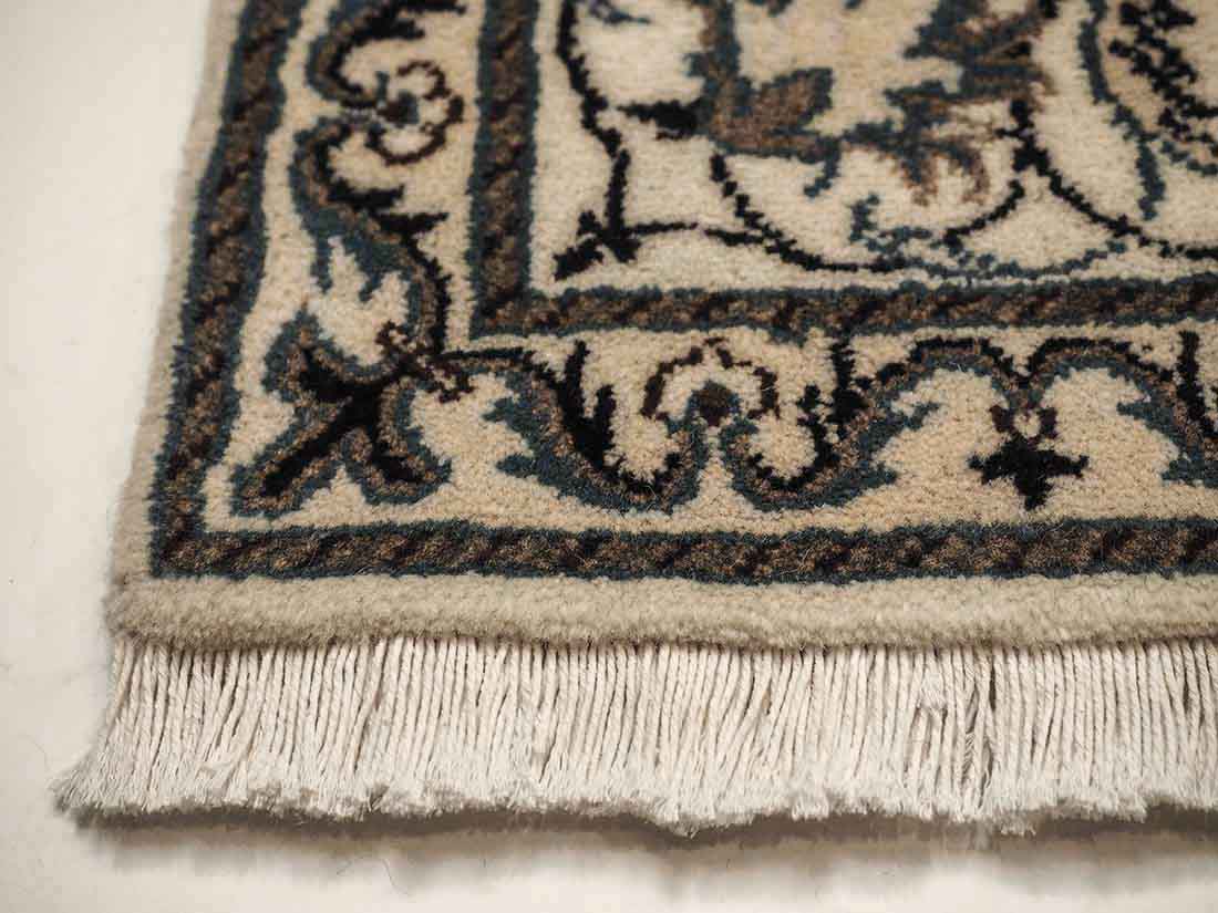 Authentic persian rug with a traditional floral design in cream and blue