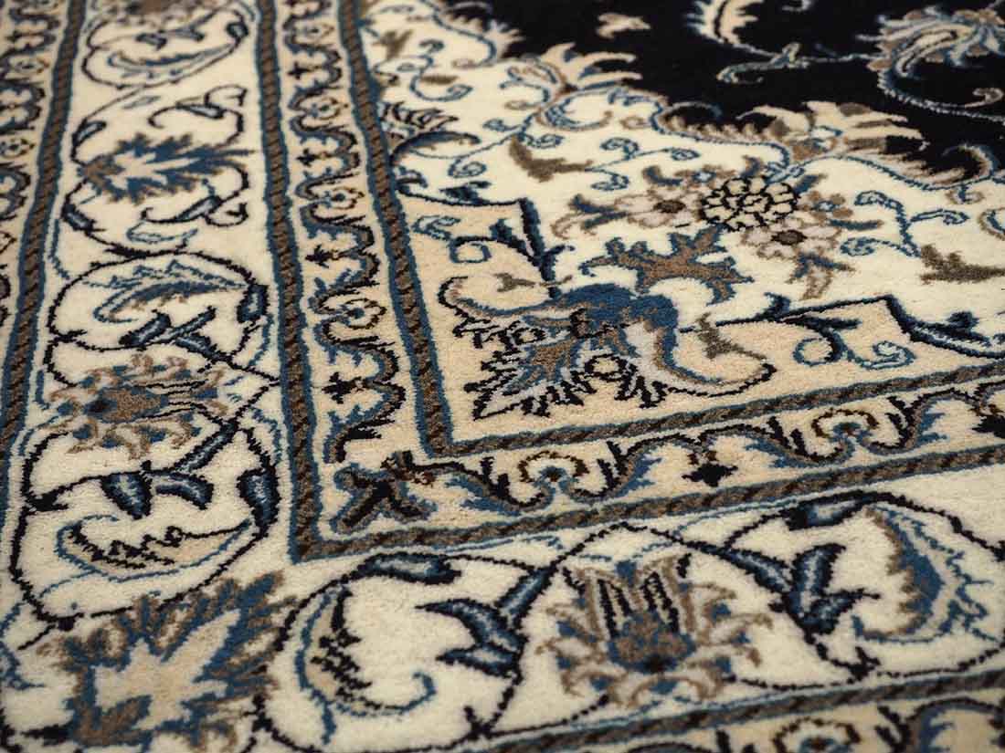 Authentic persian rug with a traditional floral design in cream and blue