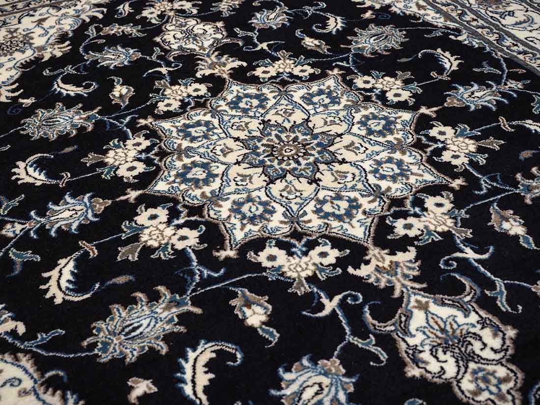 Authentic persian rug with a traditional floral design in cream and blue