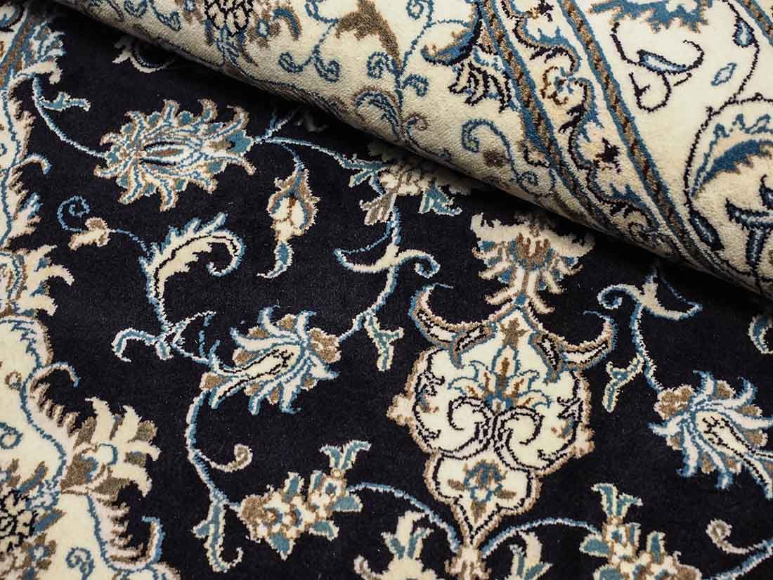 Authentic persian rug with a traditional floral design in cream and blue