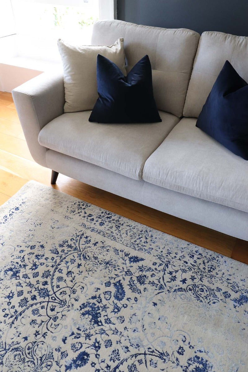cream and blue oriental rug with a floral design