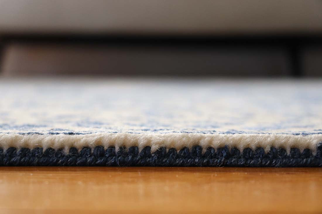 cream and blue oriental rug with a floral design
