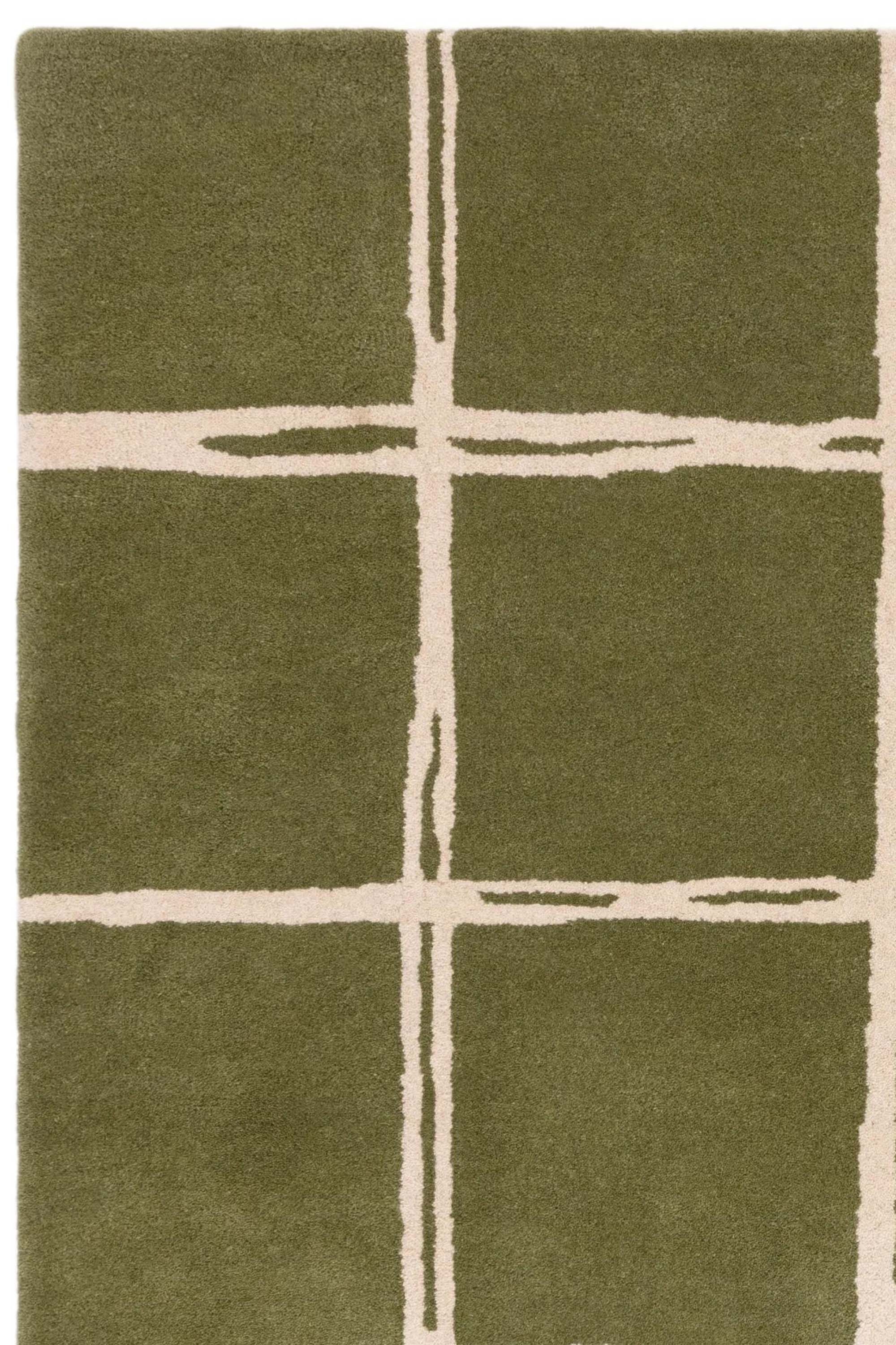 Green rug with minimal geometric pattern