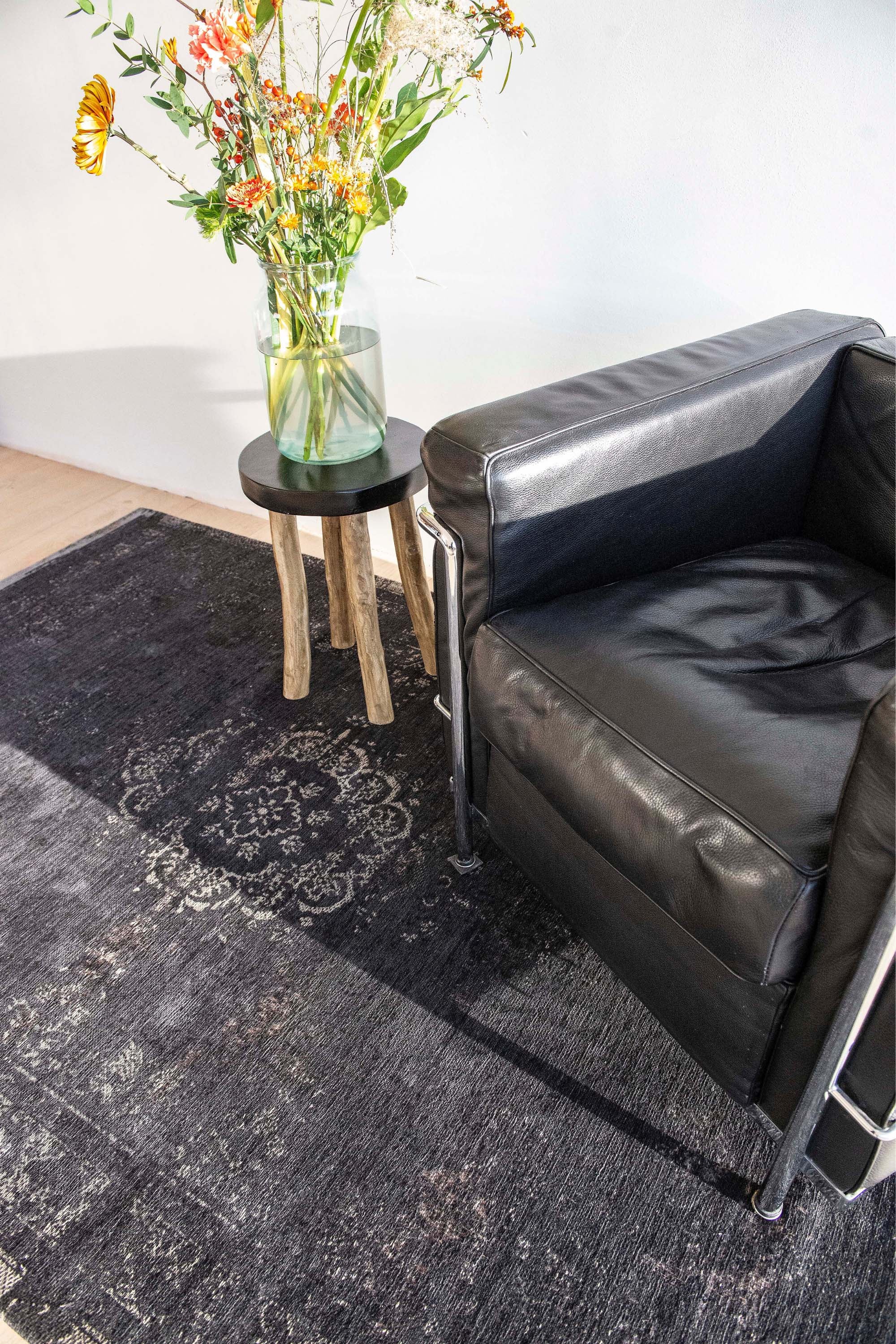 Black flatweave rug with faded persian design