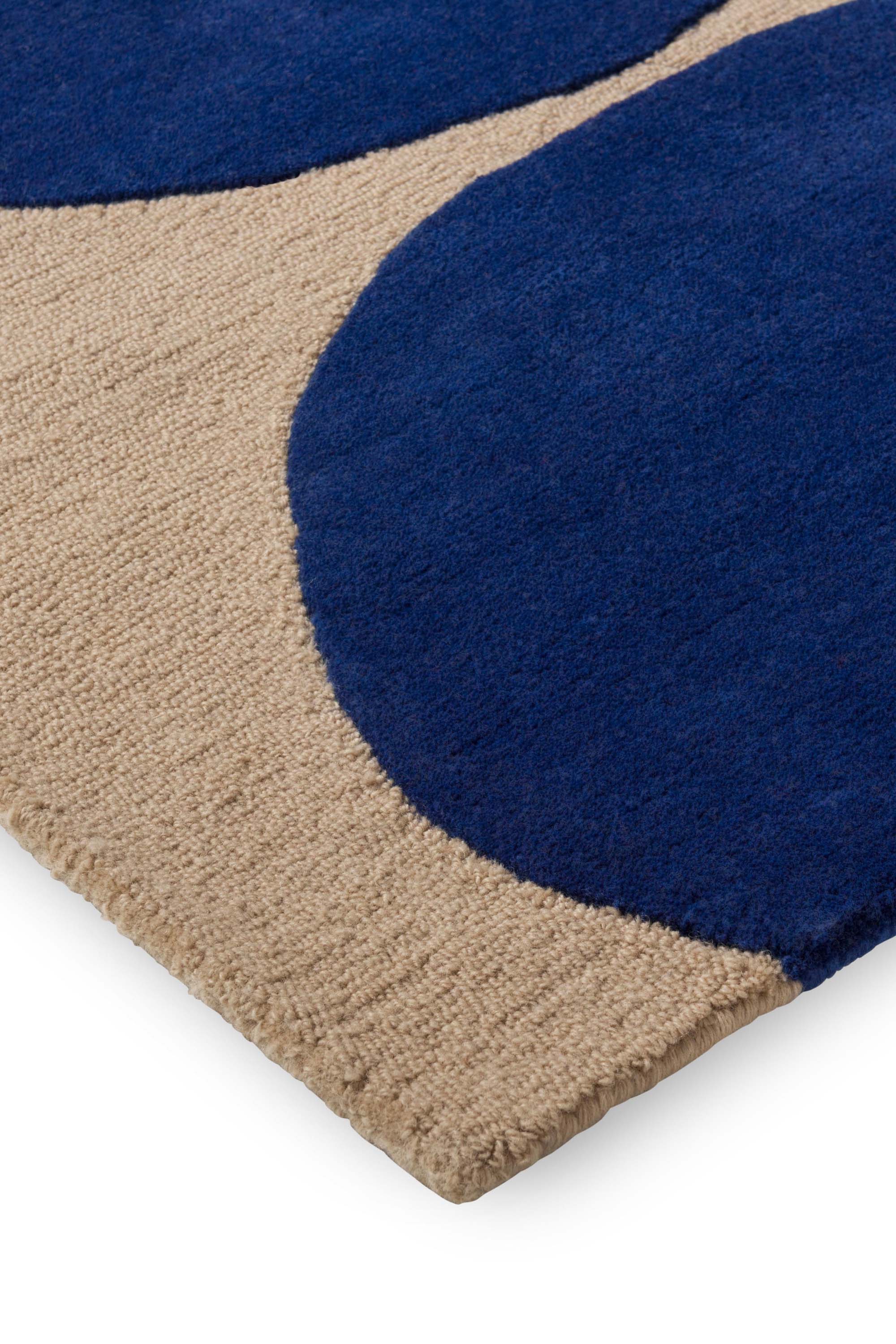 Beige rug with blue repeated circle pattern