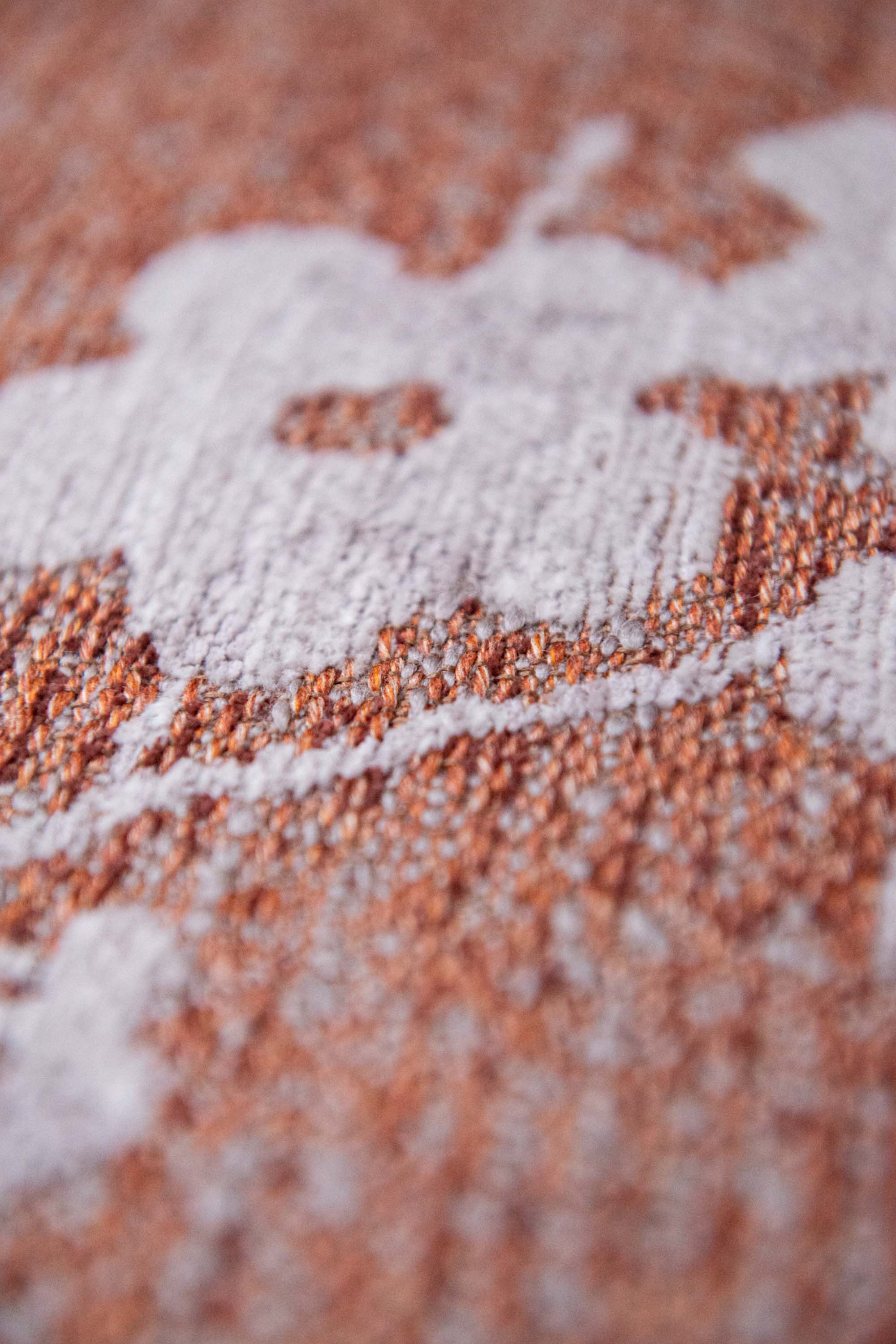 Modern abstract rug with subtle pink floral pattern