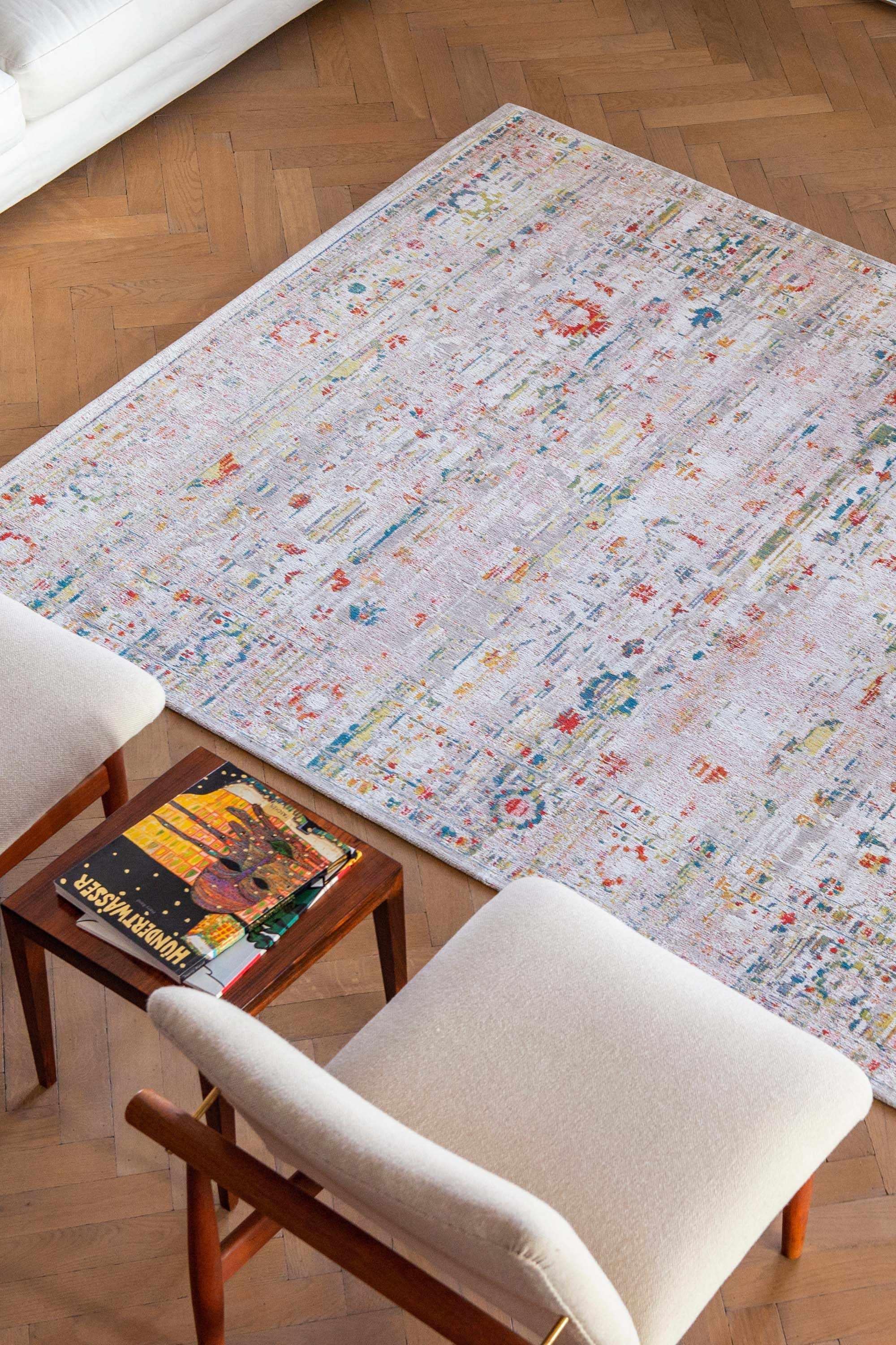 Distressed beige rug with turkish floral medallions and border in teal, terracotta and yellow