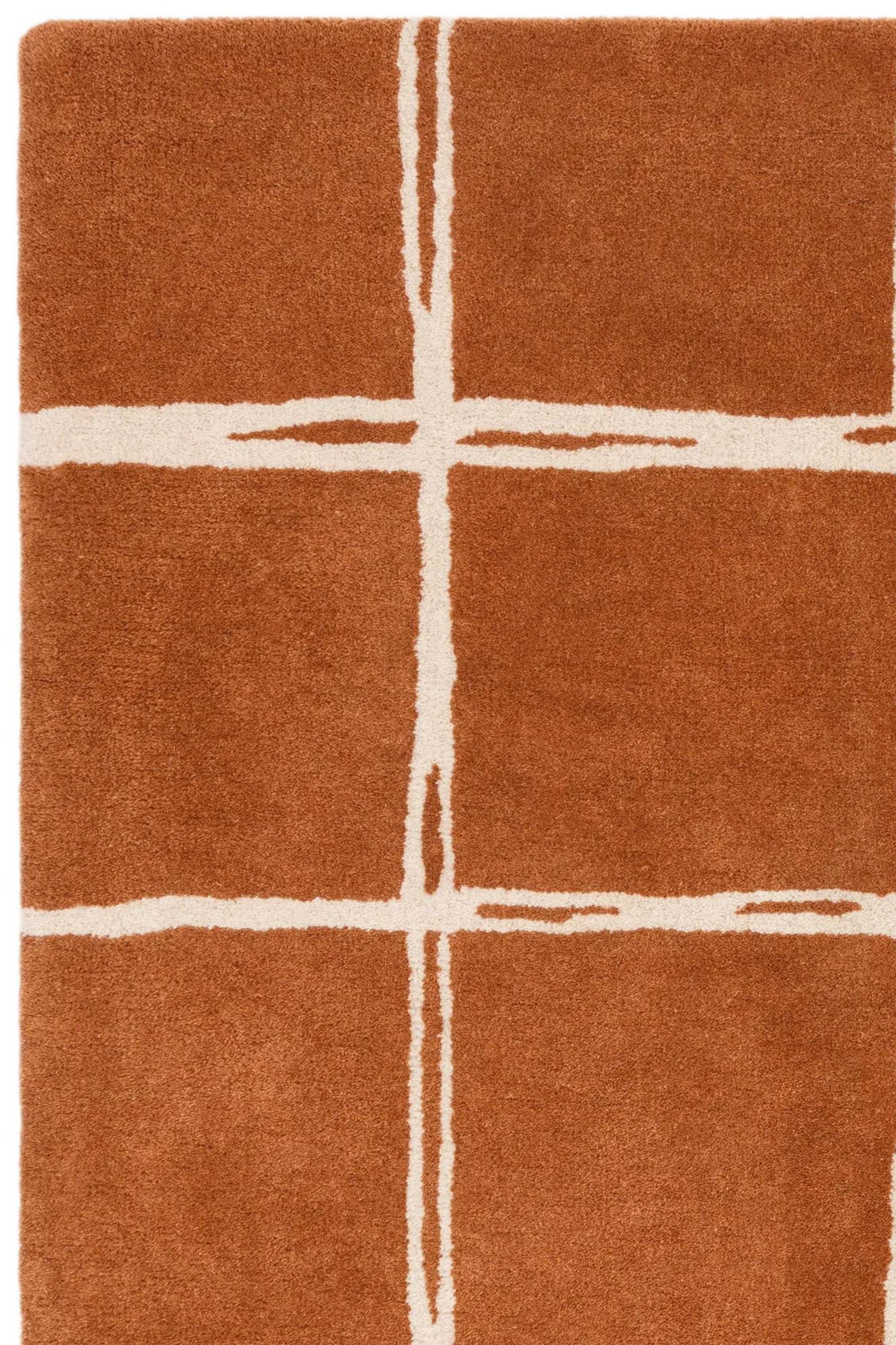 Orange rug with minimal geometric pattern
