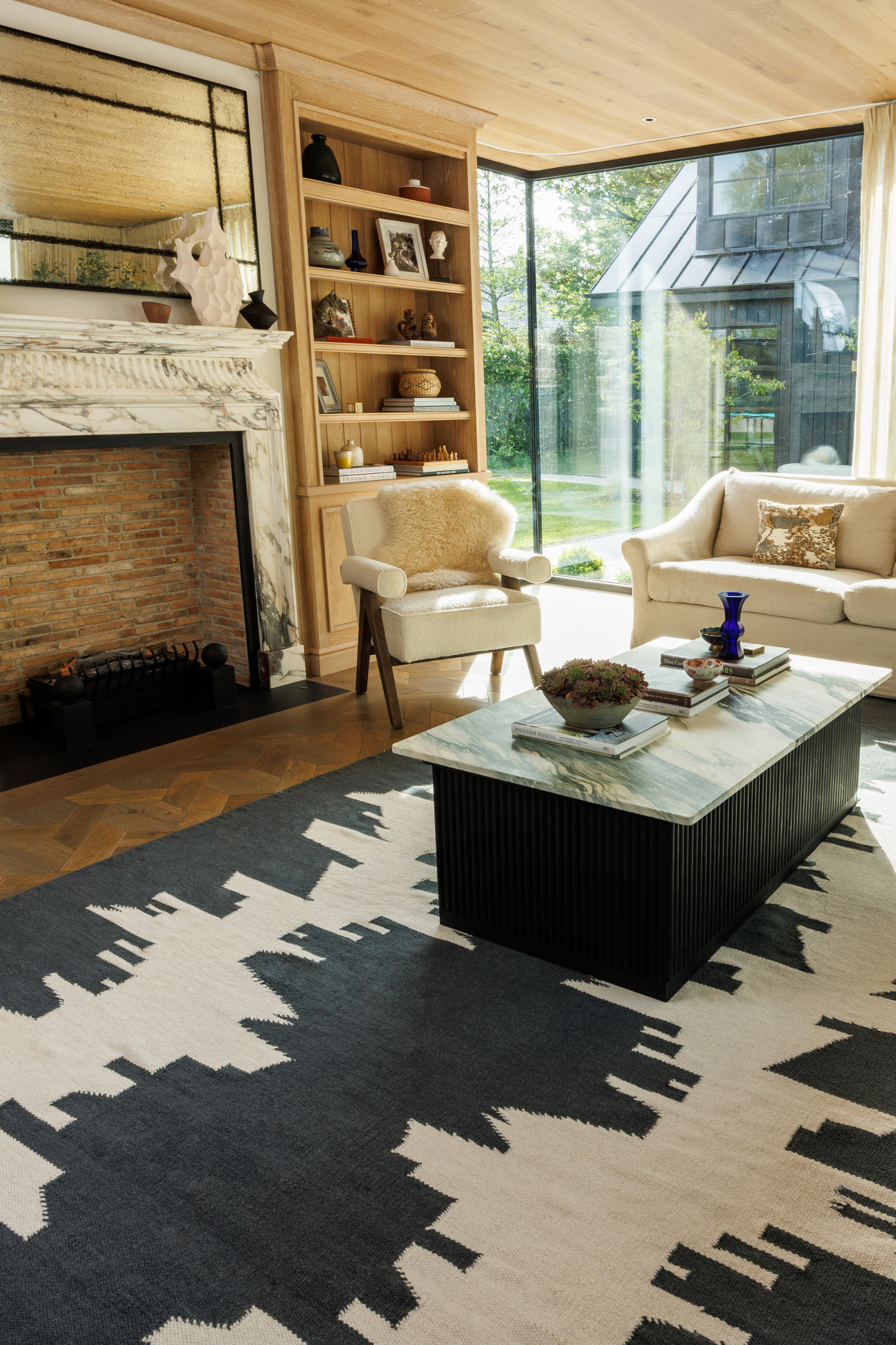 a black and white wool and cotton rug featuring a monochromatic modern abstract design placed in a living room