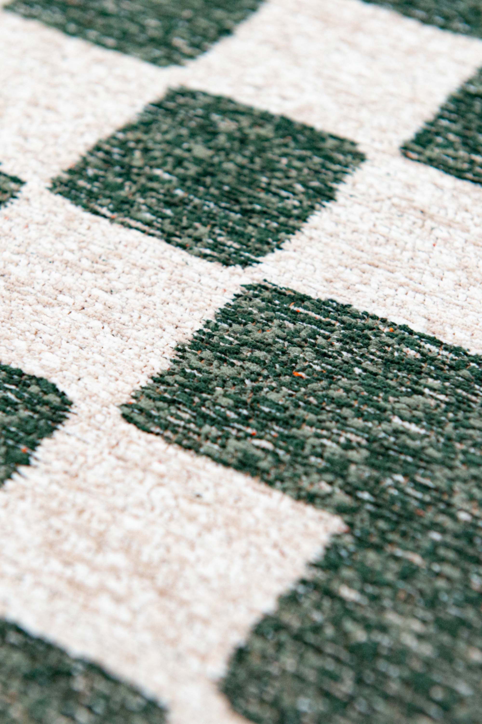 Abstract geometric rug with green, orange, and white tones