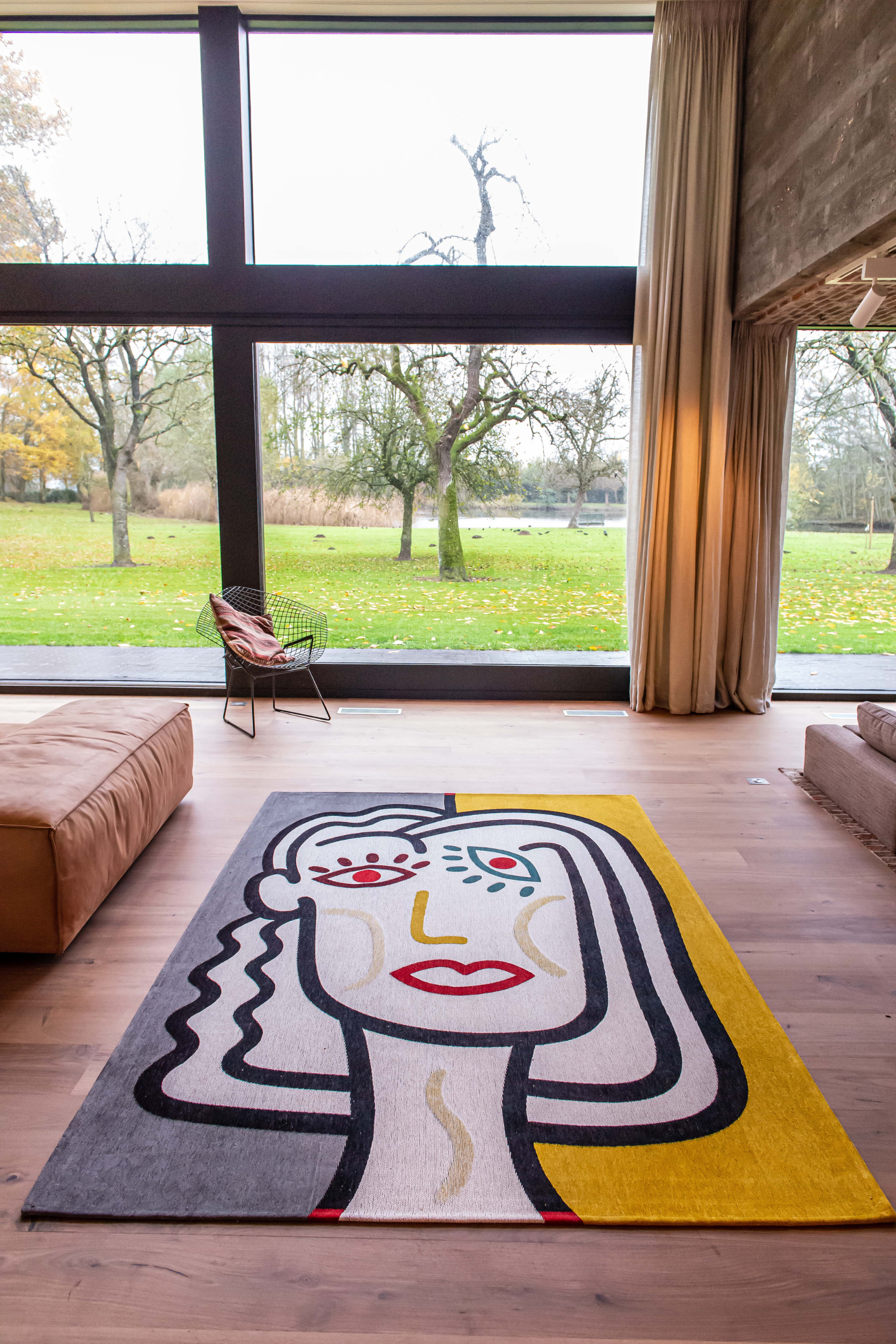 yellow, blue and red rug with an abstract face