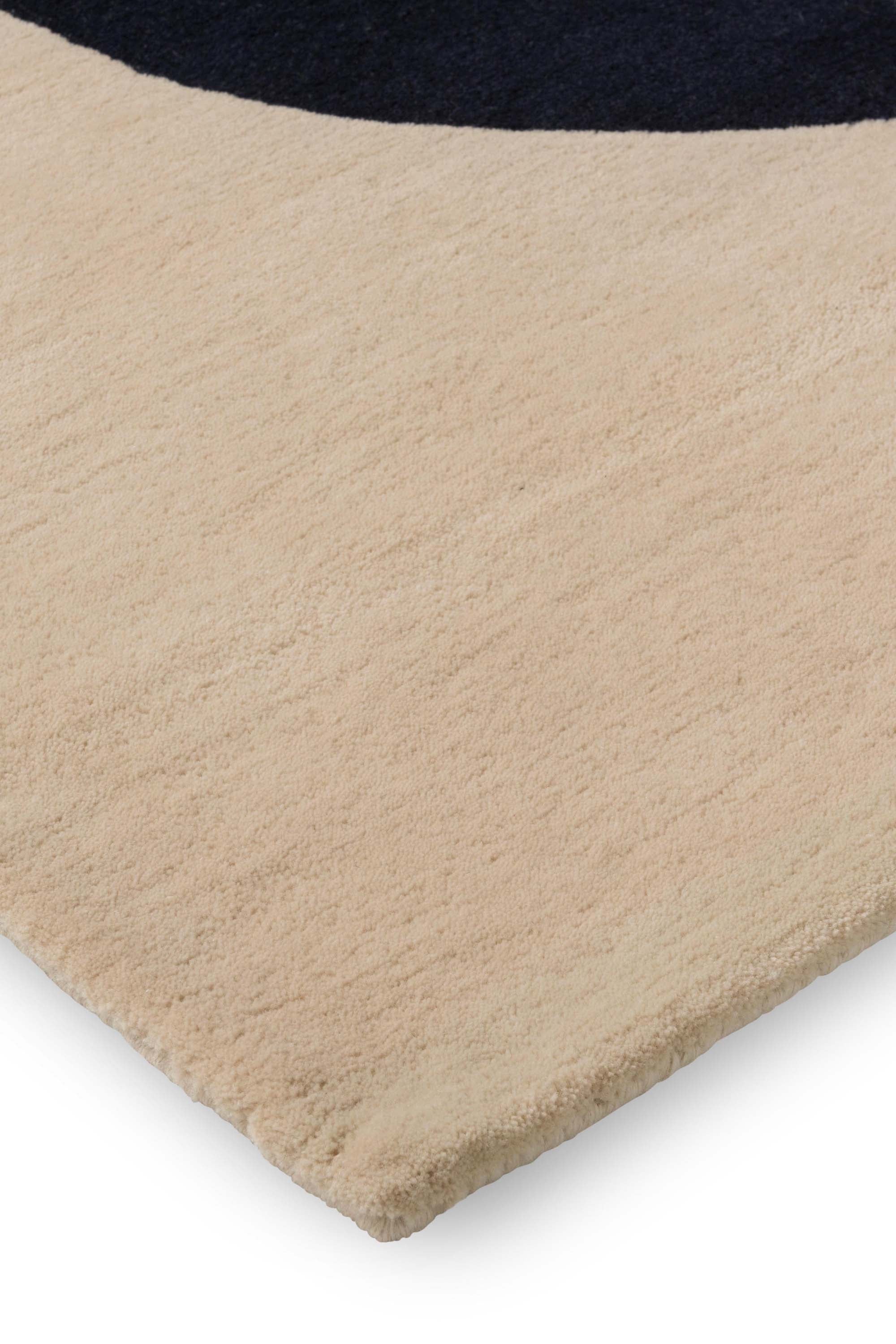 Beige and green rug with cream blue pattern